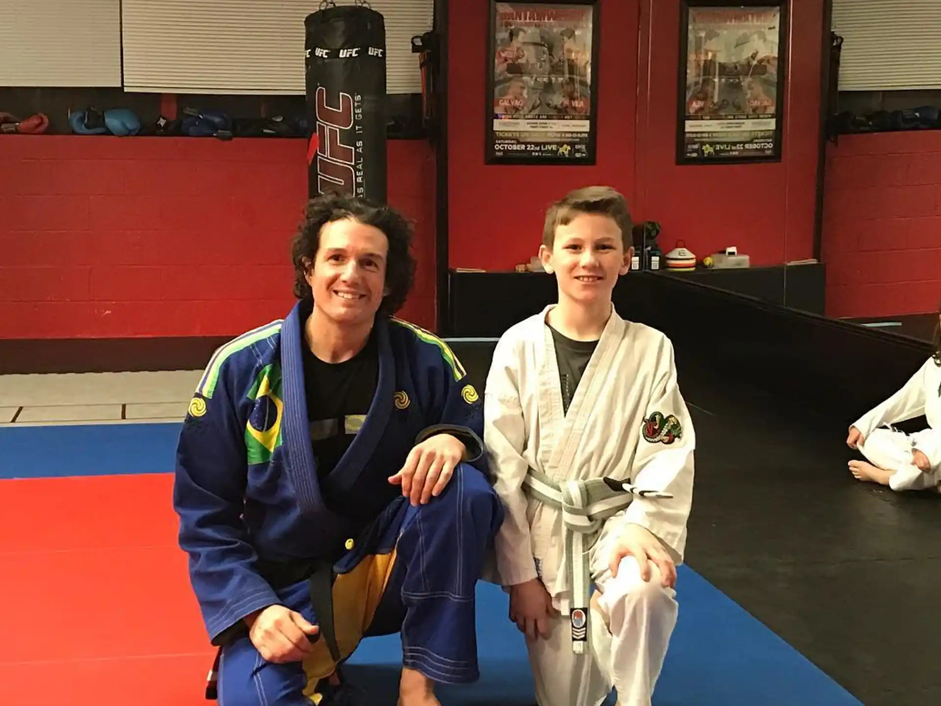 a man and a boy in karate uniforms