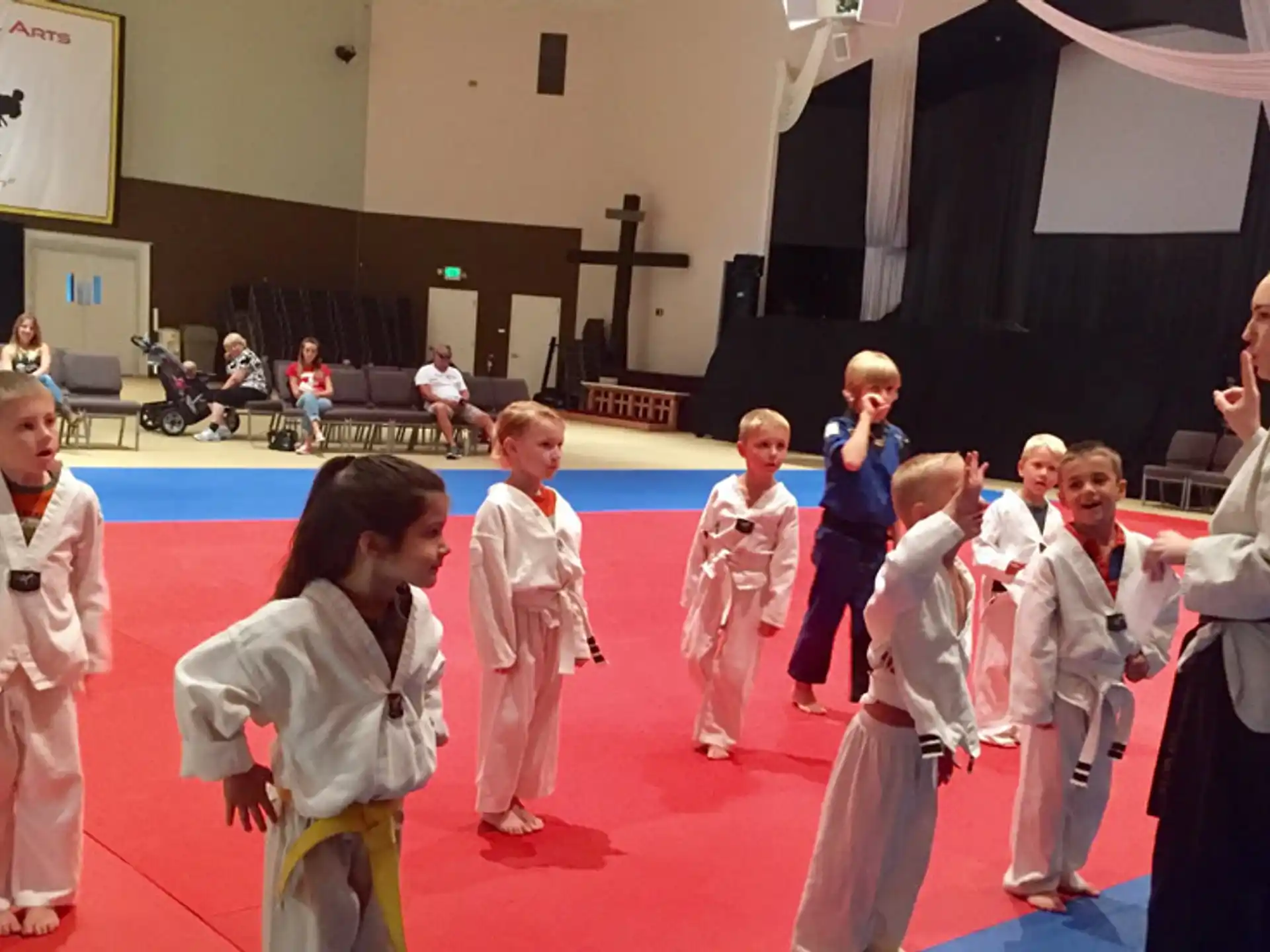 a group of children in karate uniforms