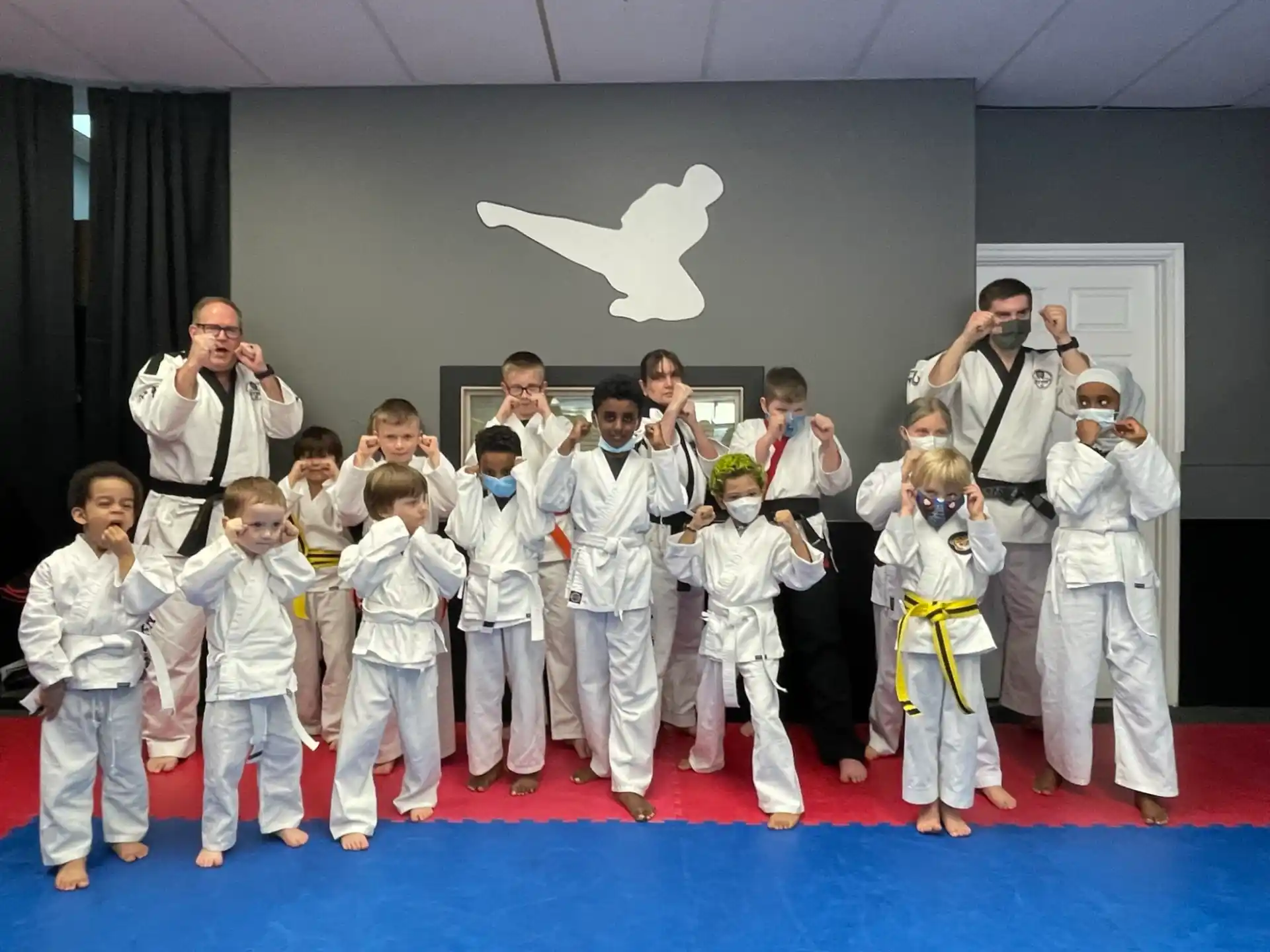 a group of people in karate uniforms