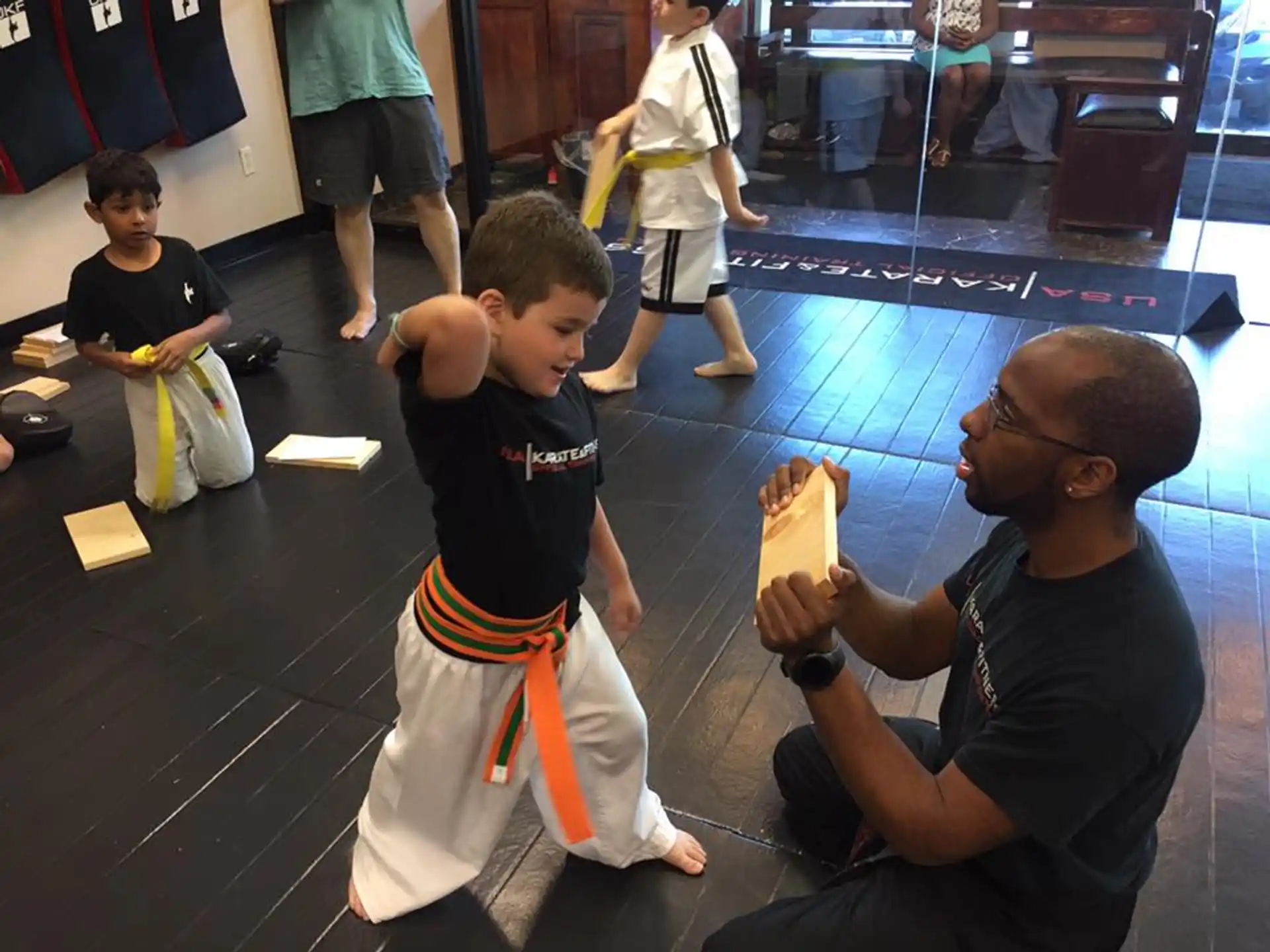 a person and a boy sitting on the floor