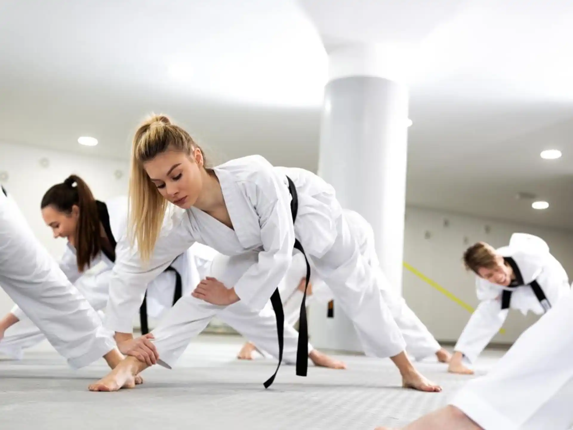 a group of people in karate uniforms