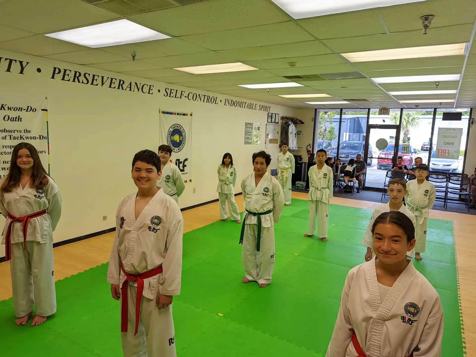 a group of people in white karate uniforms
