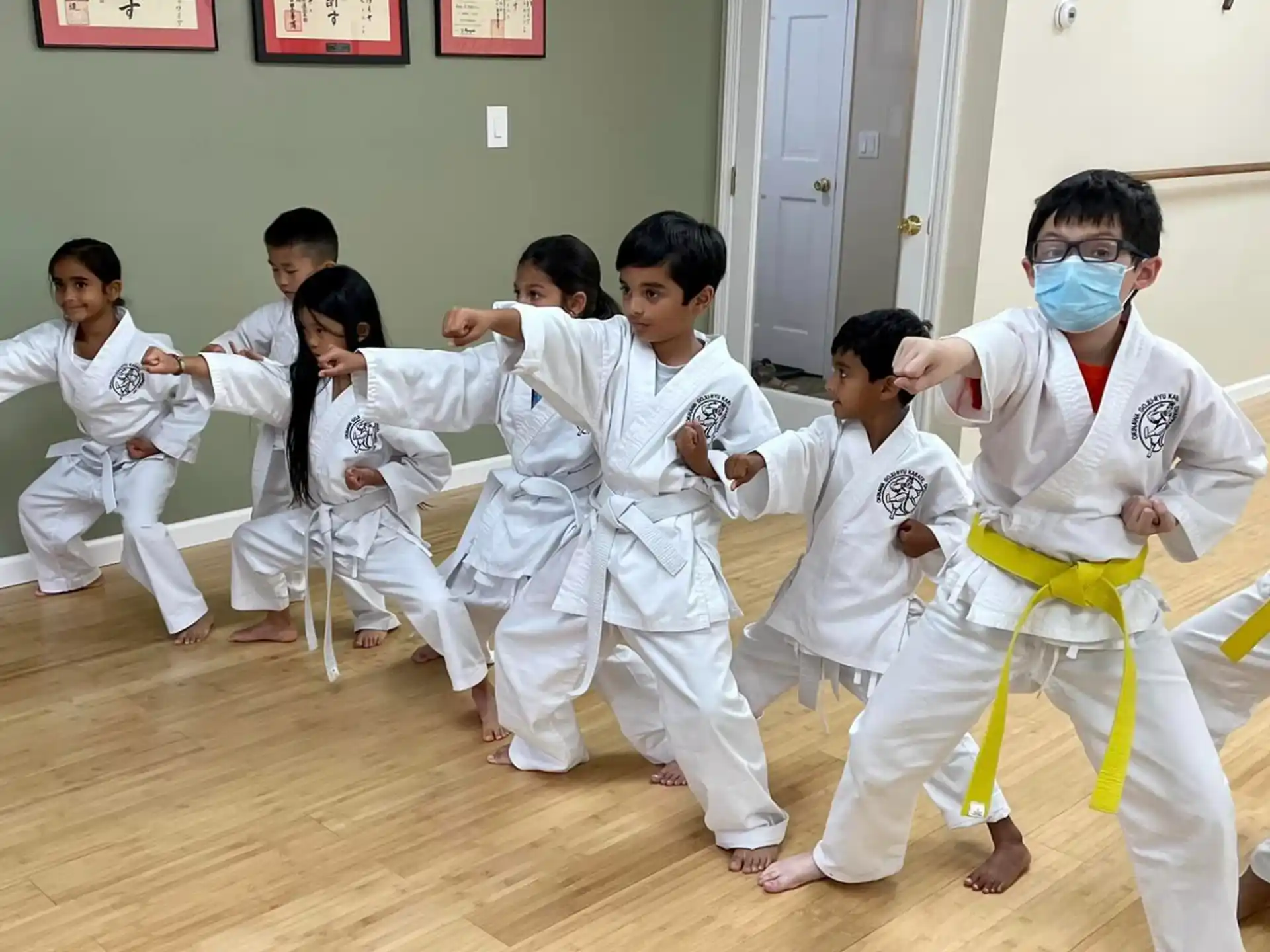 a group of children in white karate uniforms