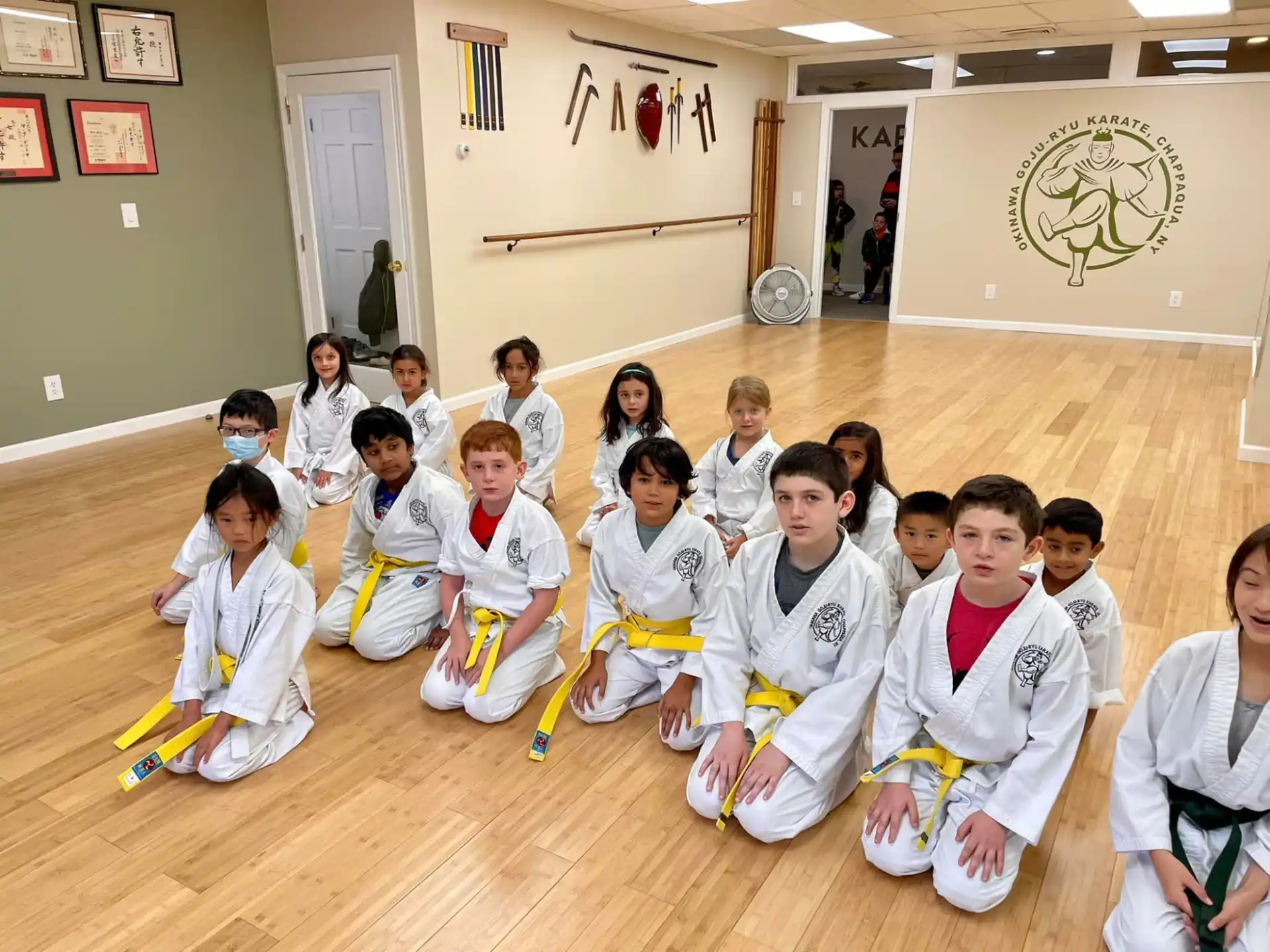 a group of children in white uniforms