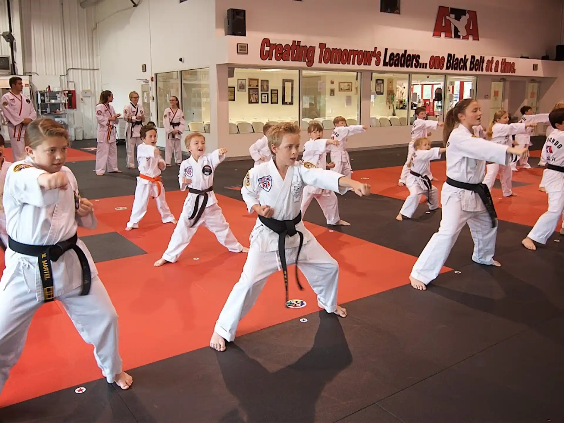 a group of children in karate uniforms