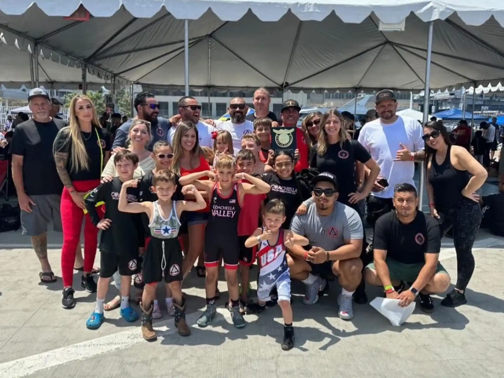 a group of people posing for a photo under a tent