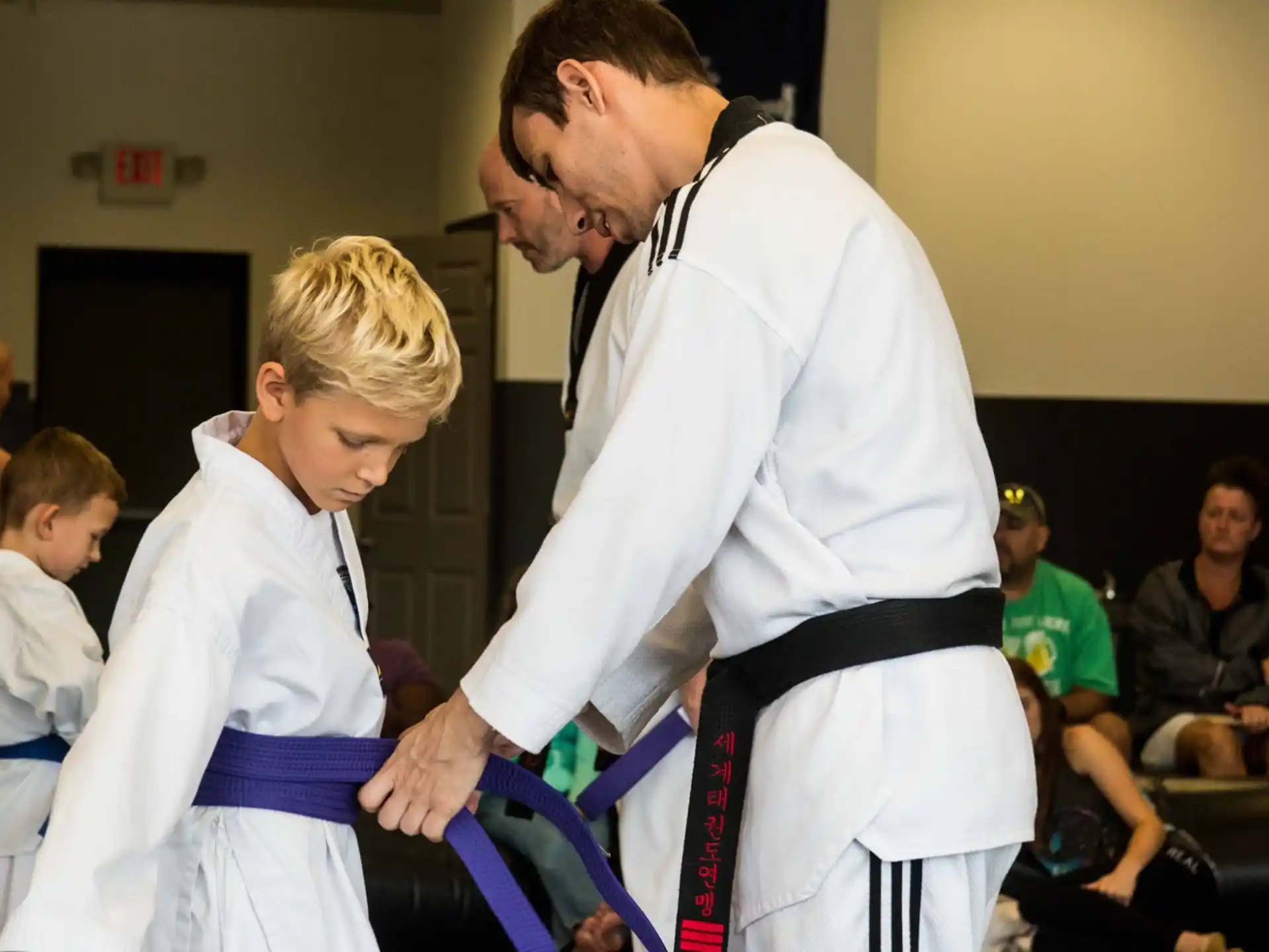 a person and a boy in karate uniforms