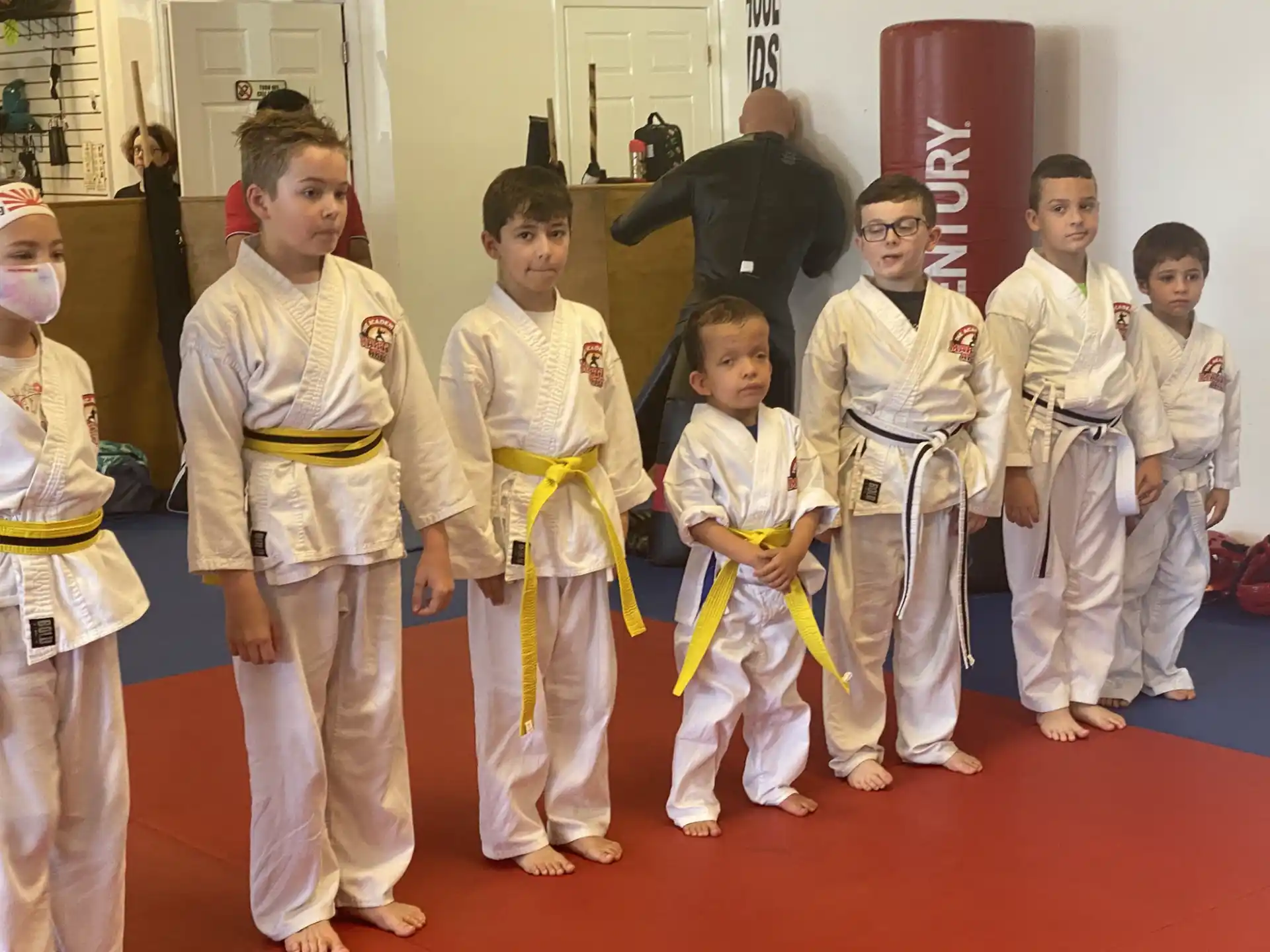 a group of children in karate uniforms