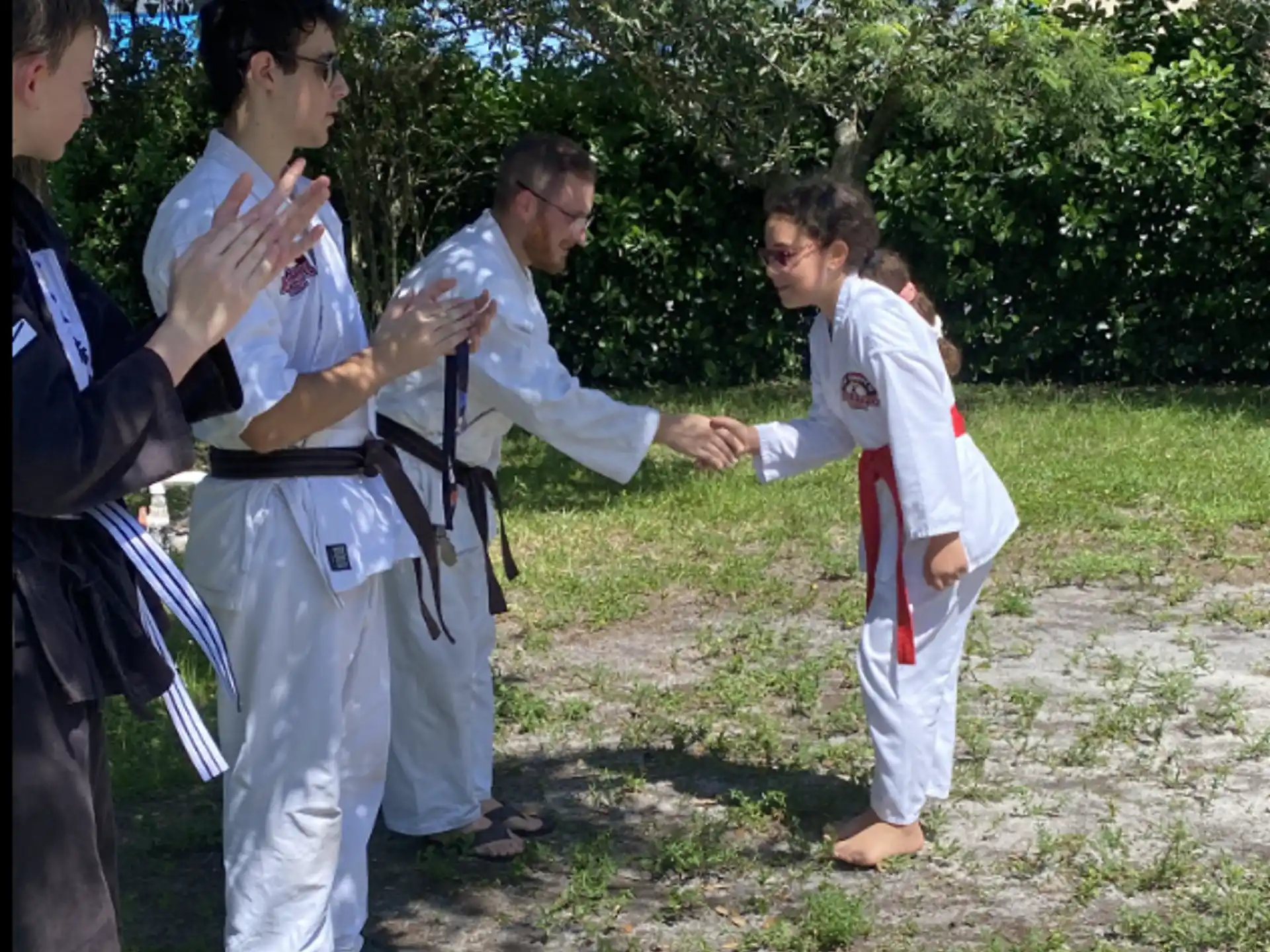 a group of people in karate uniforms