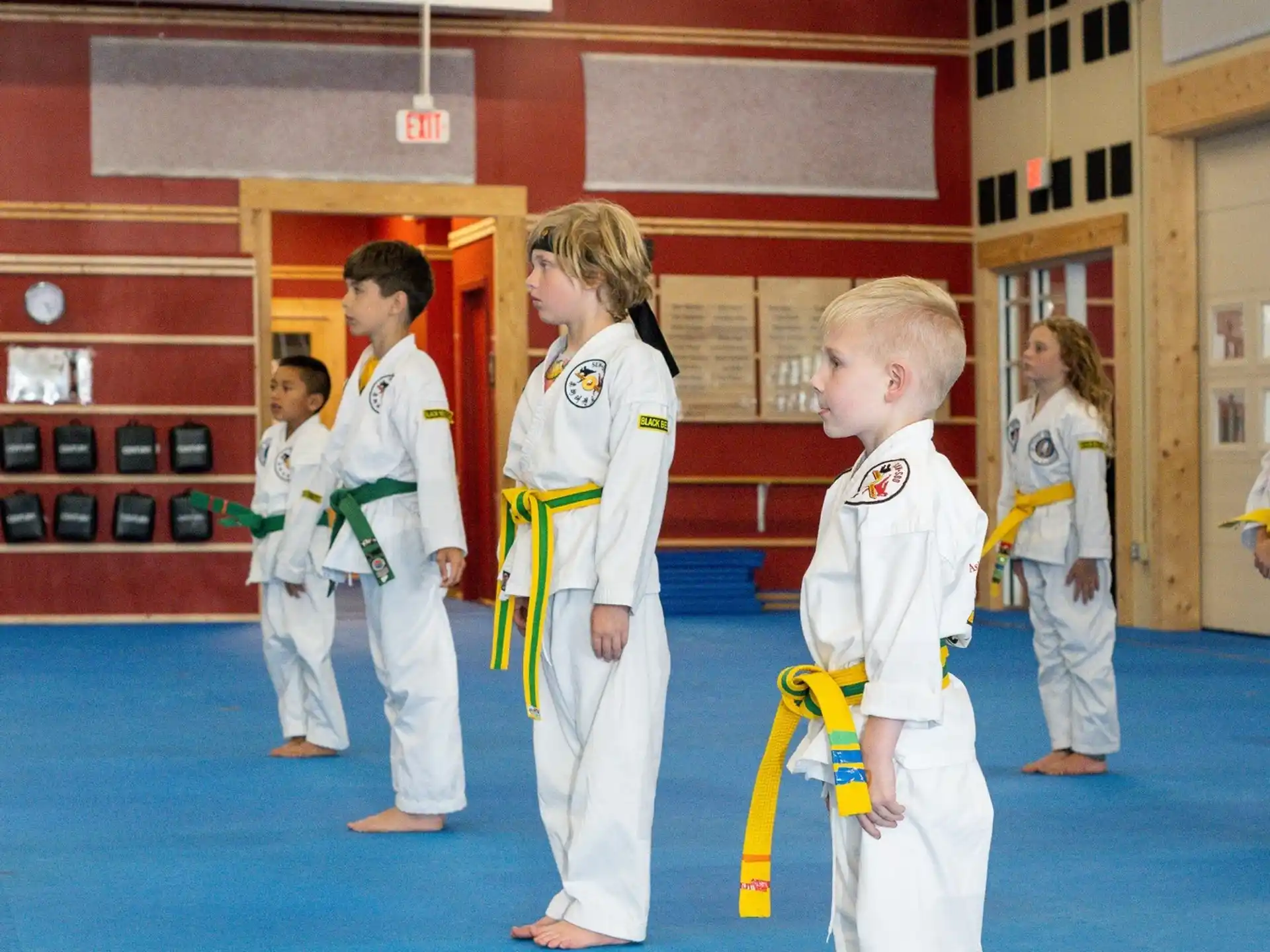 a group of children in white karate uniforms