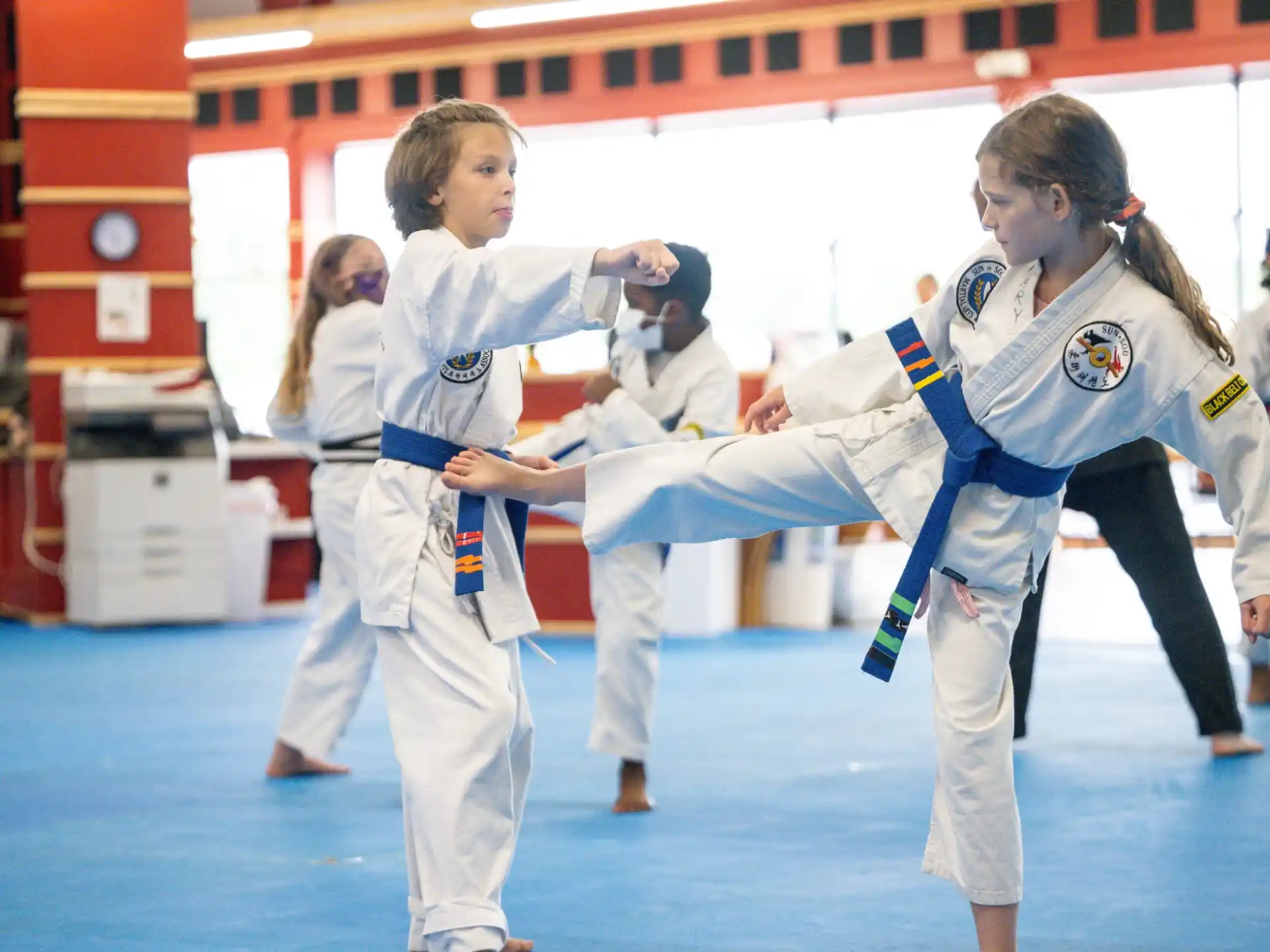 a group of girls in karate uniforms