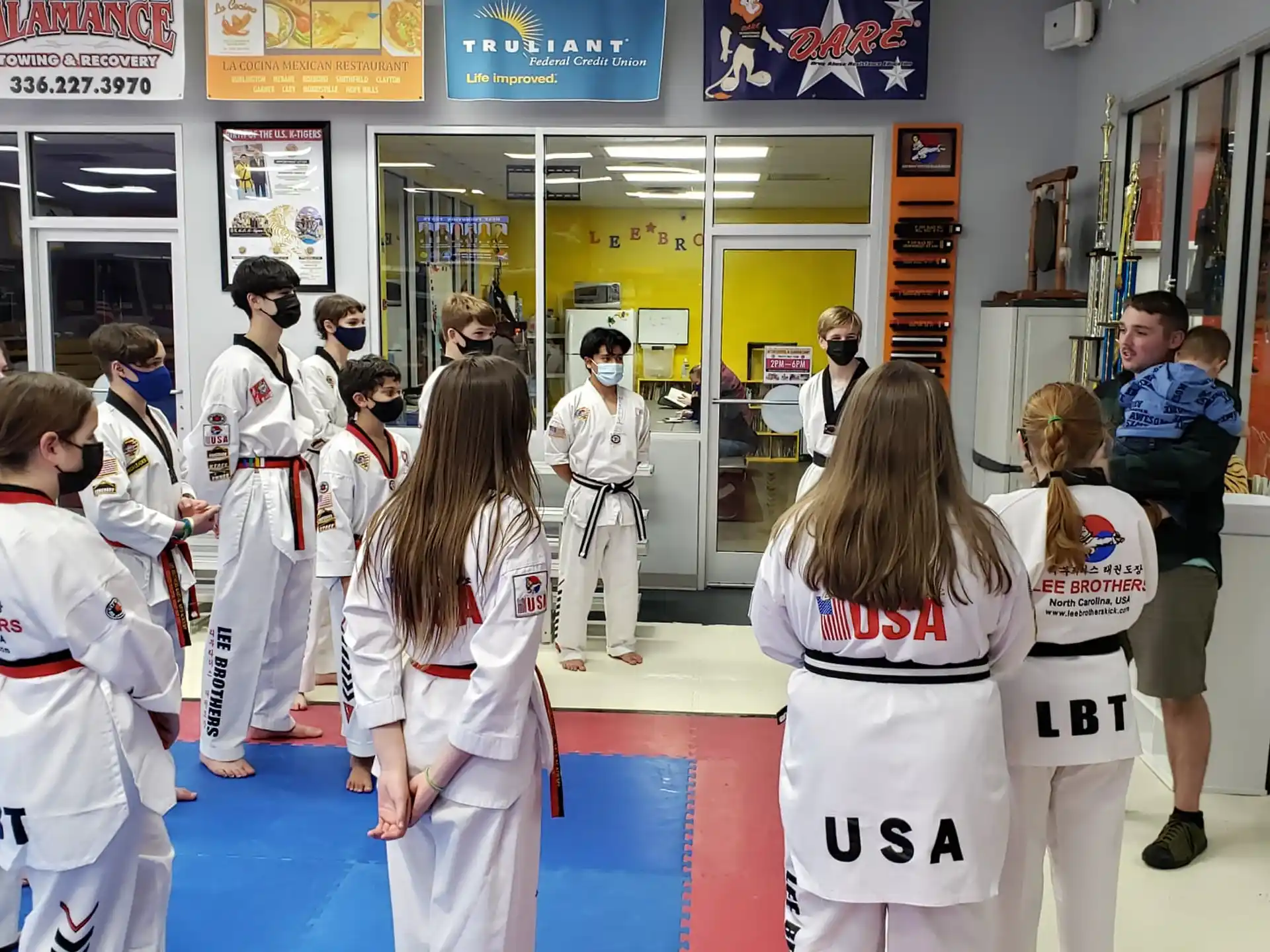 a group of people in white karate uniforms