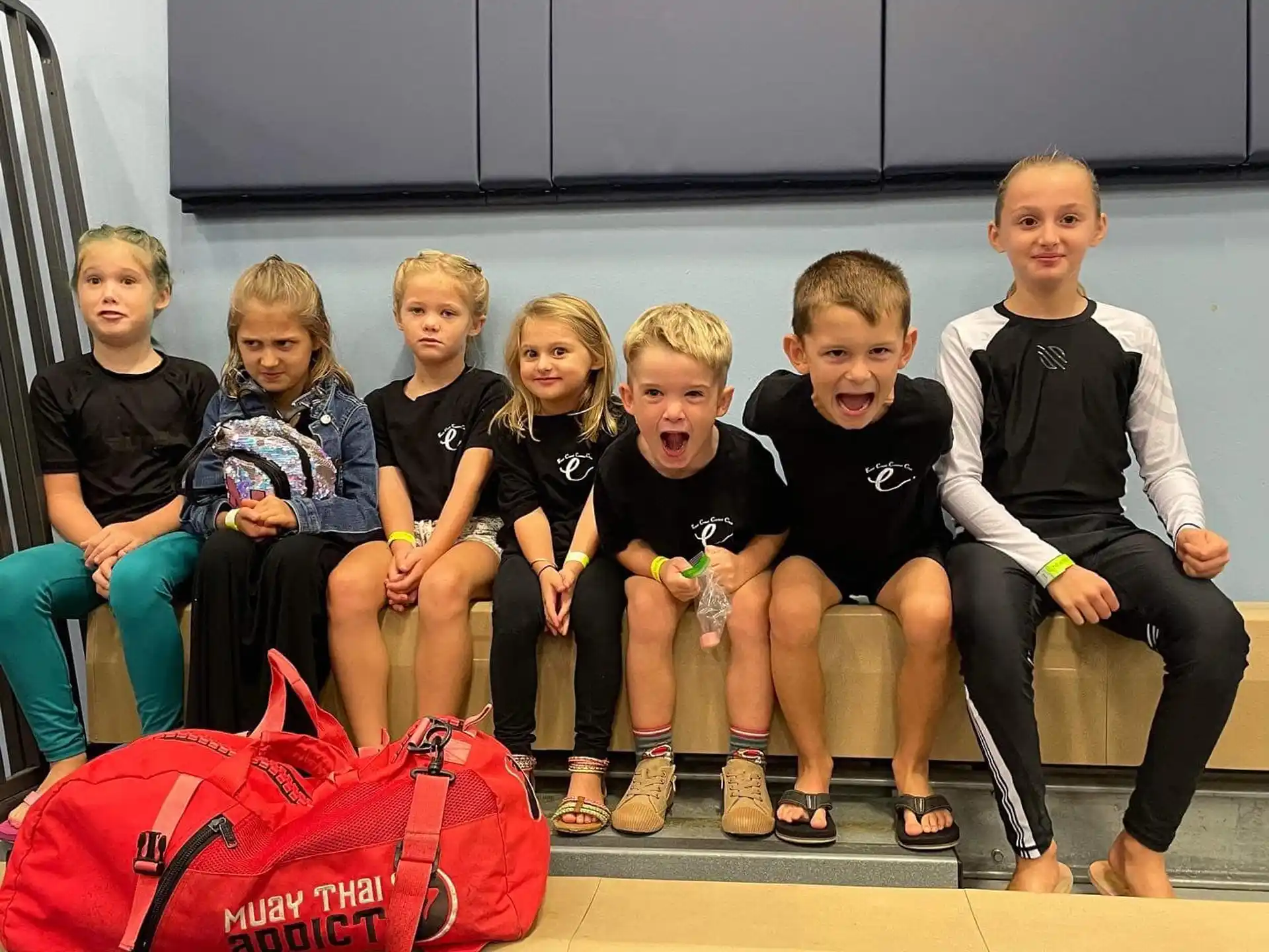 a group of children sitting on a bench