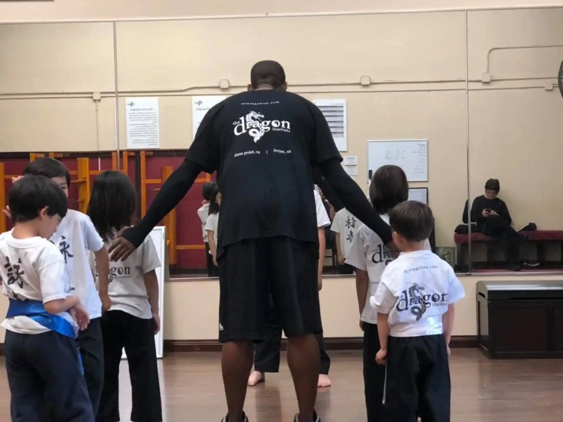 a man standing in front of a group of kids
