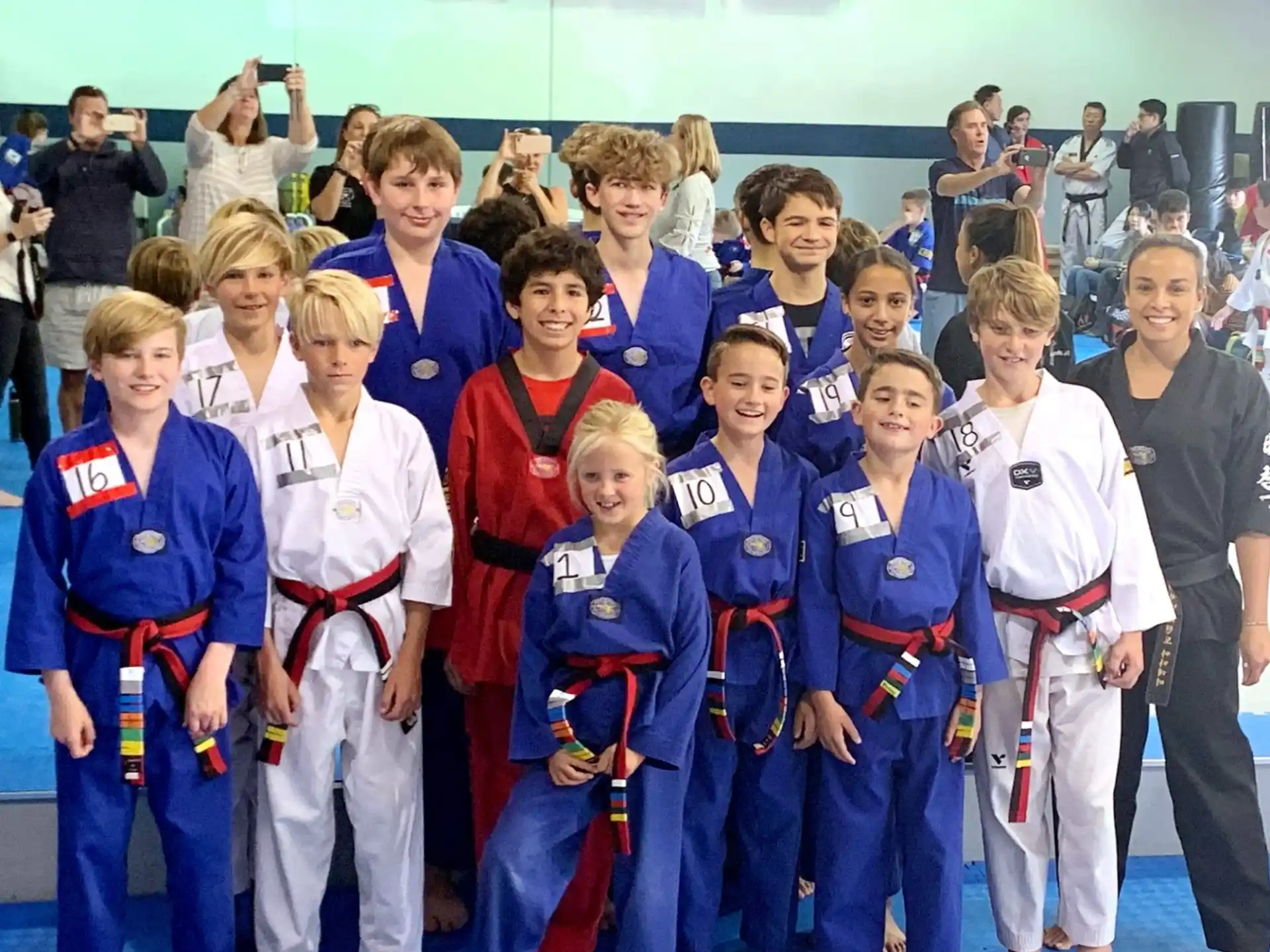 a group of children in karate uniforms