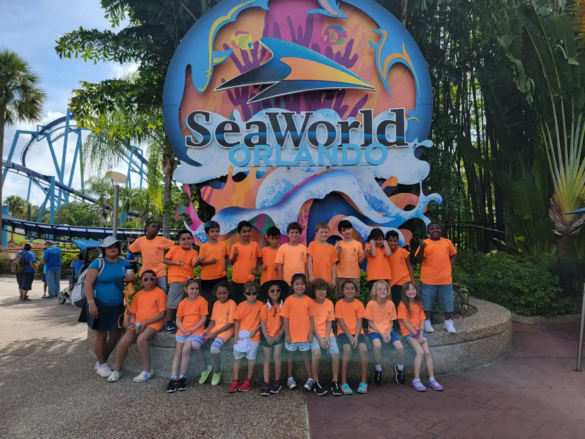 a group of people posing for a photo in front of a sign