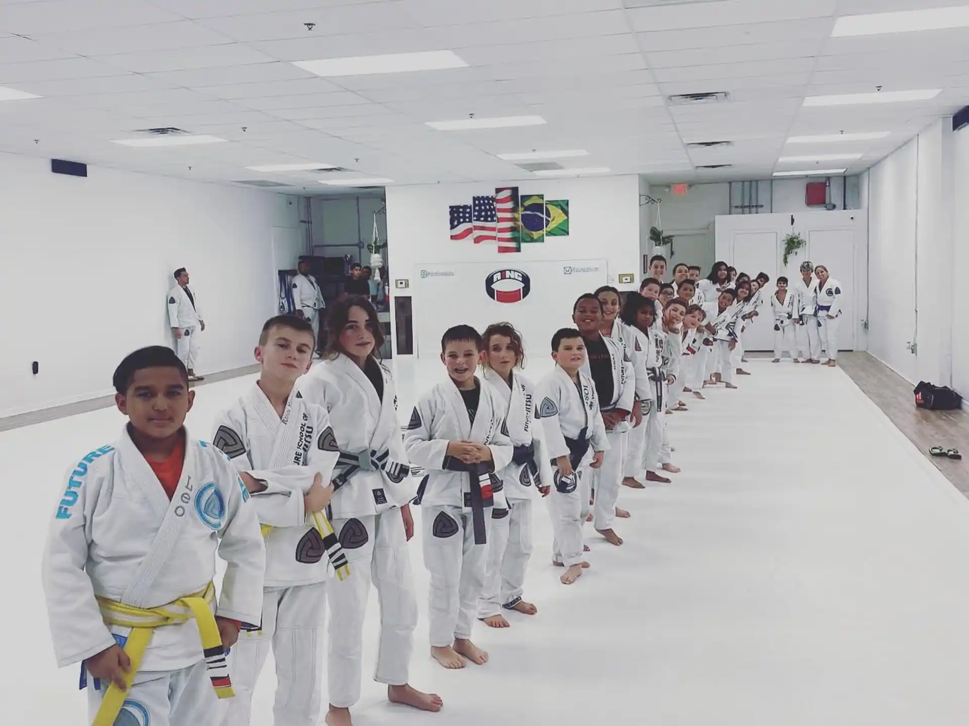 a group of people in white karate uniforms