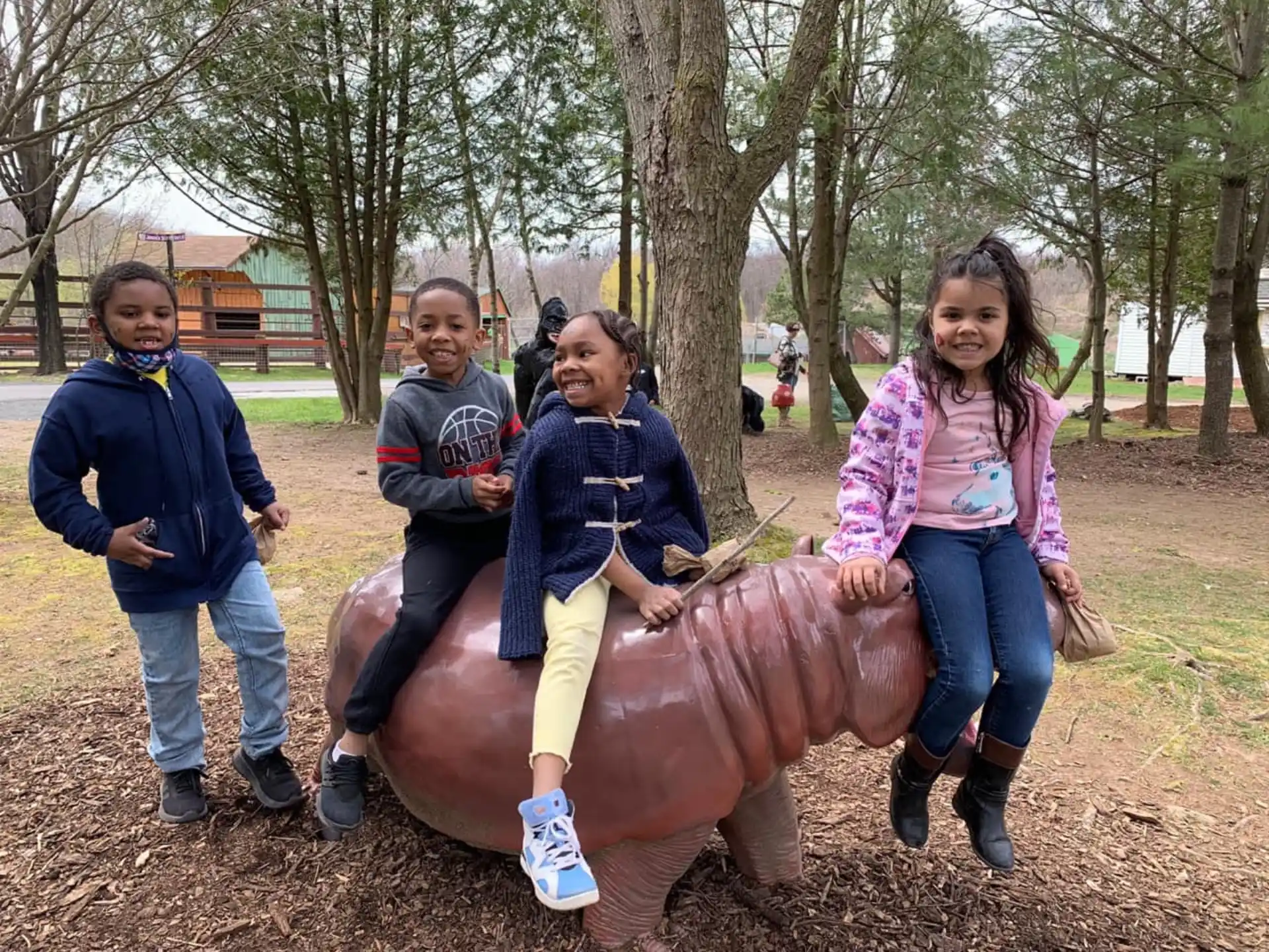 a group of people posing with a large animal