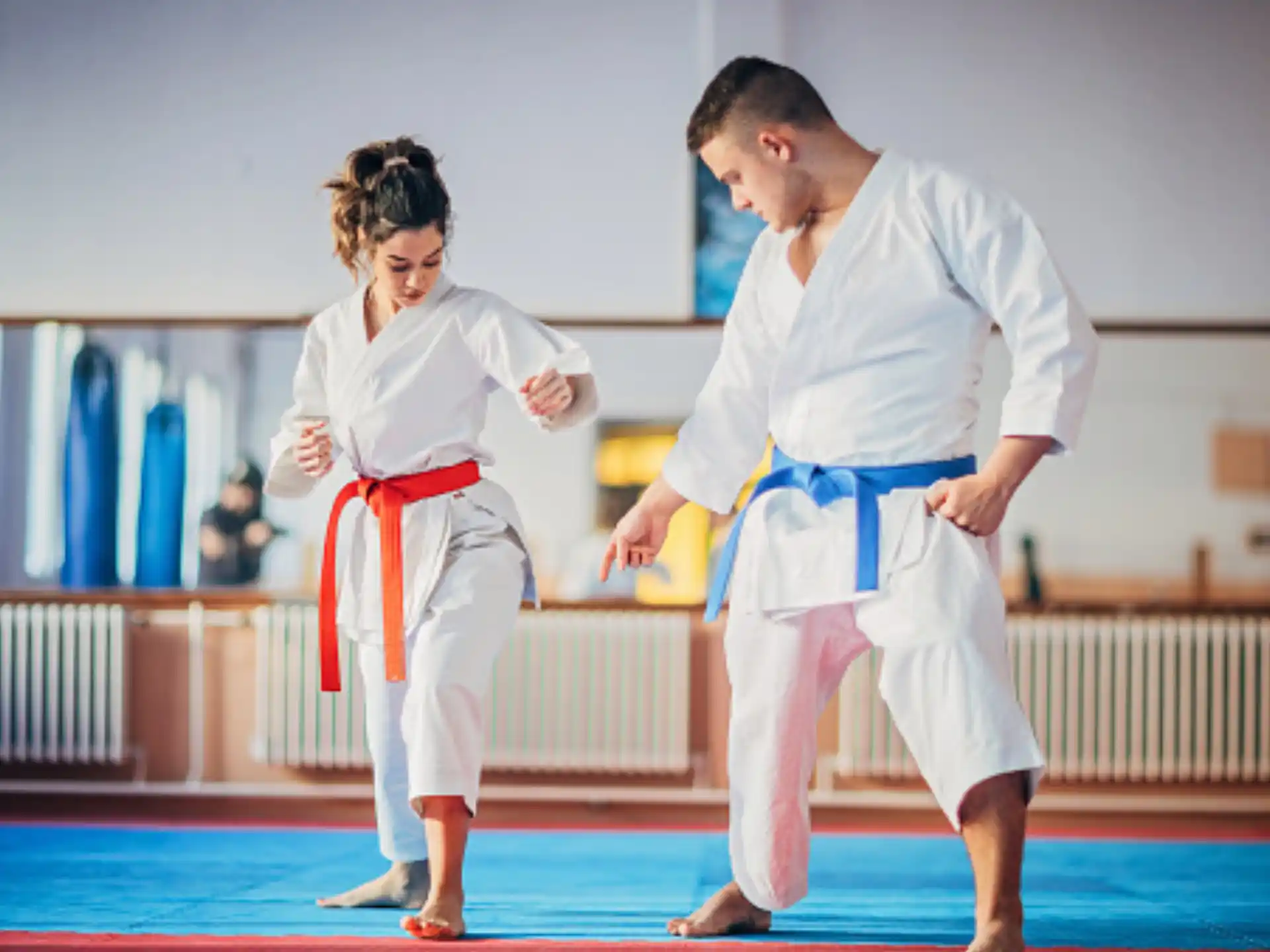 a man and a woman in karate uniforms