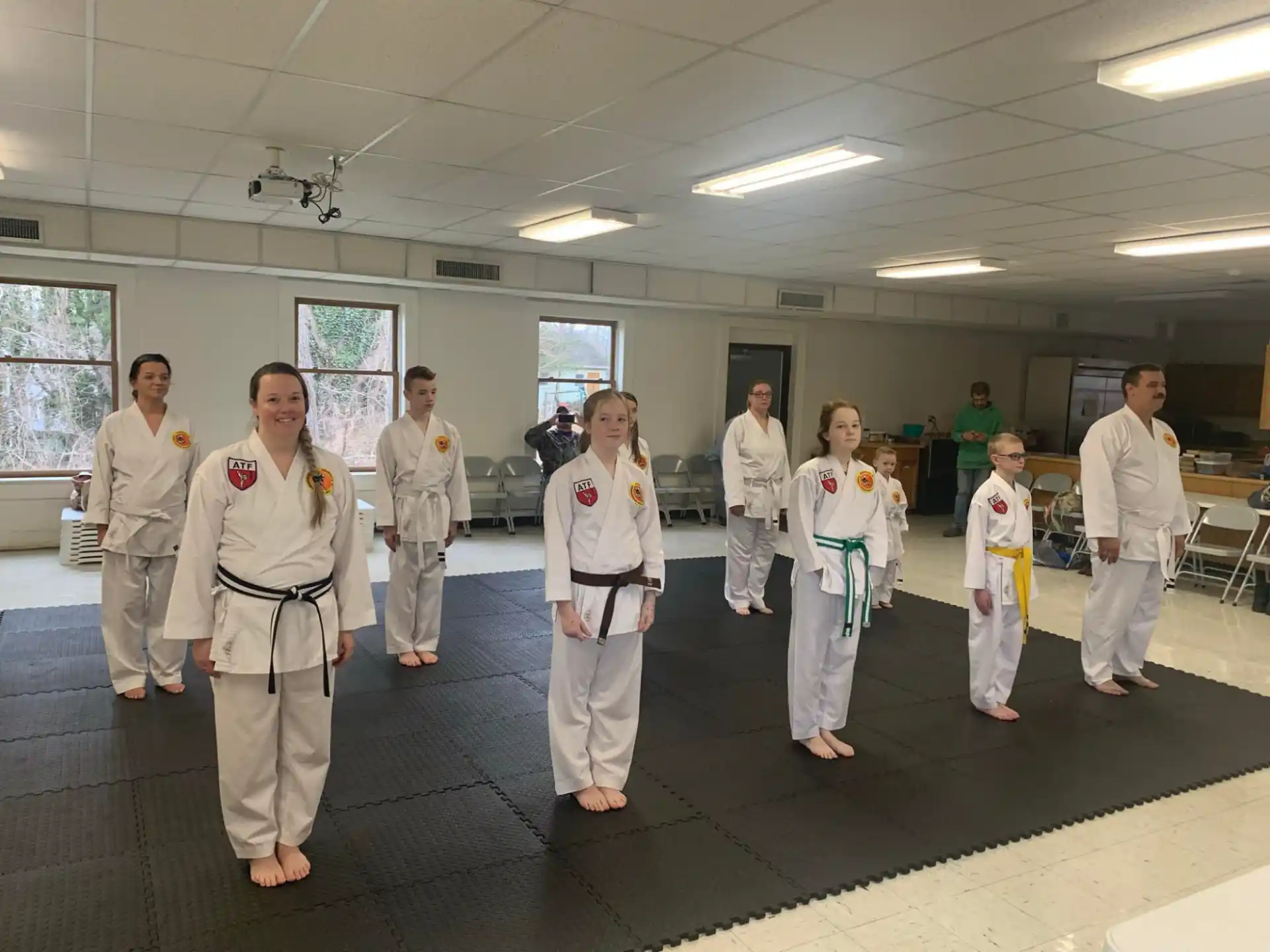 a group of people in white karate uniforms