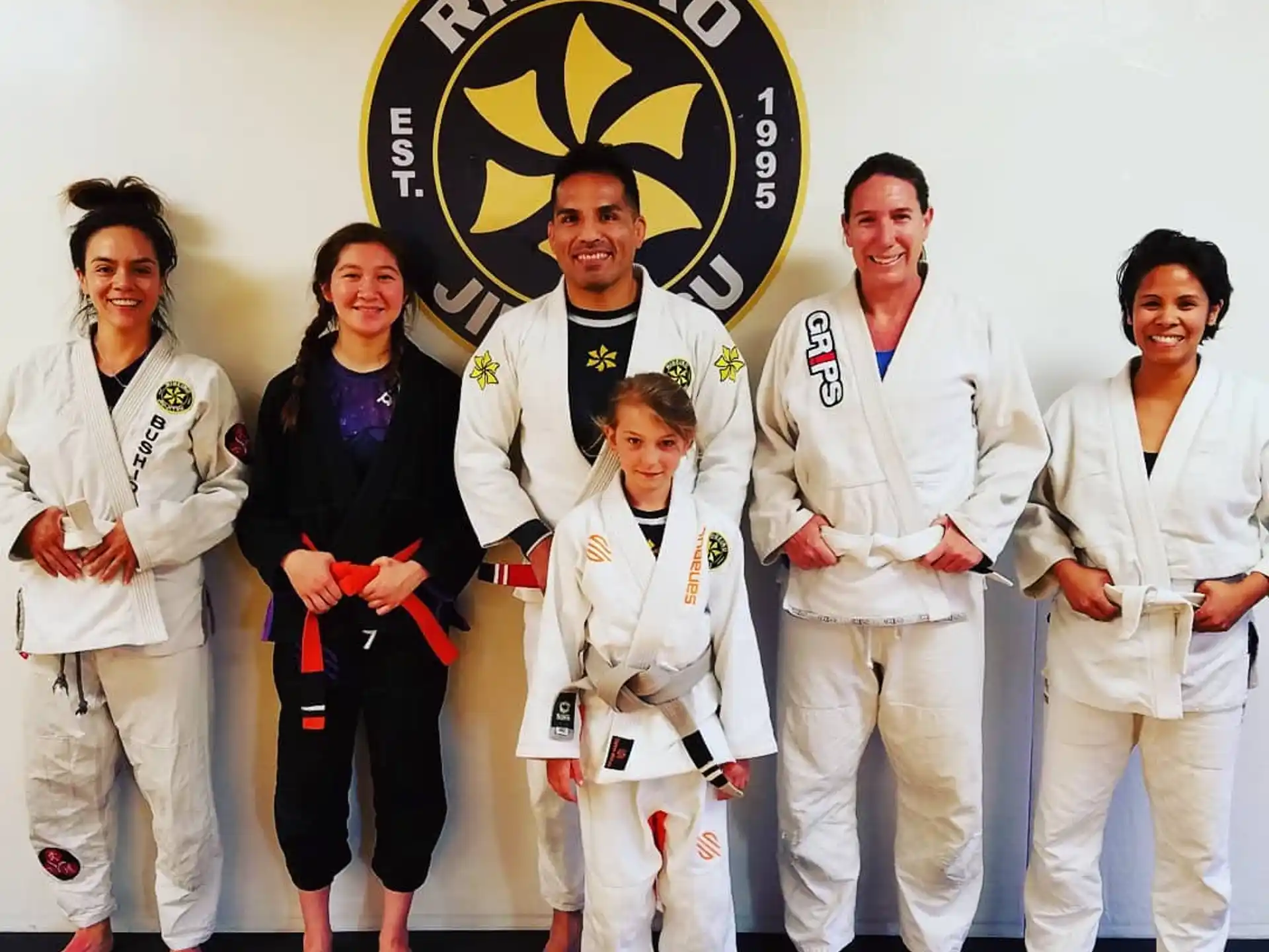a group of people in white karate uniforms