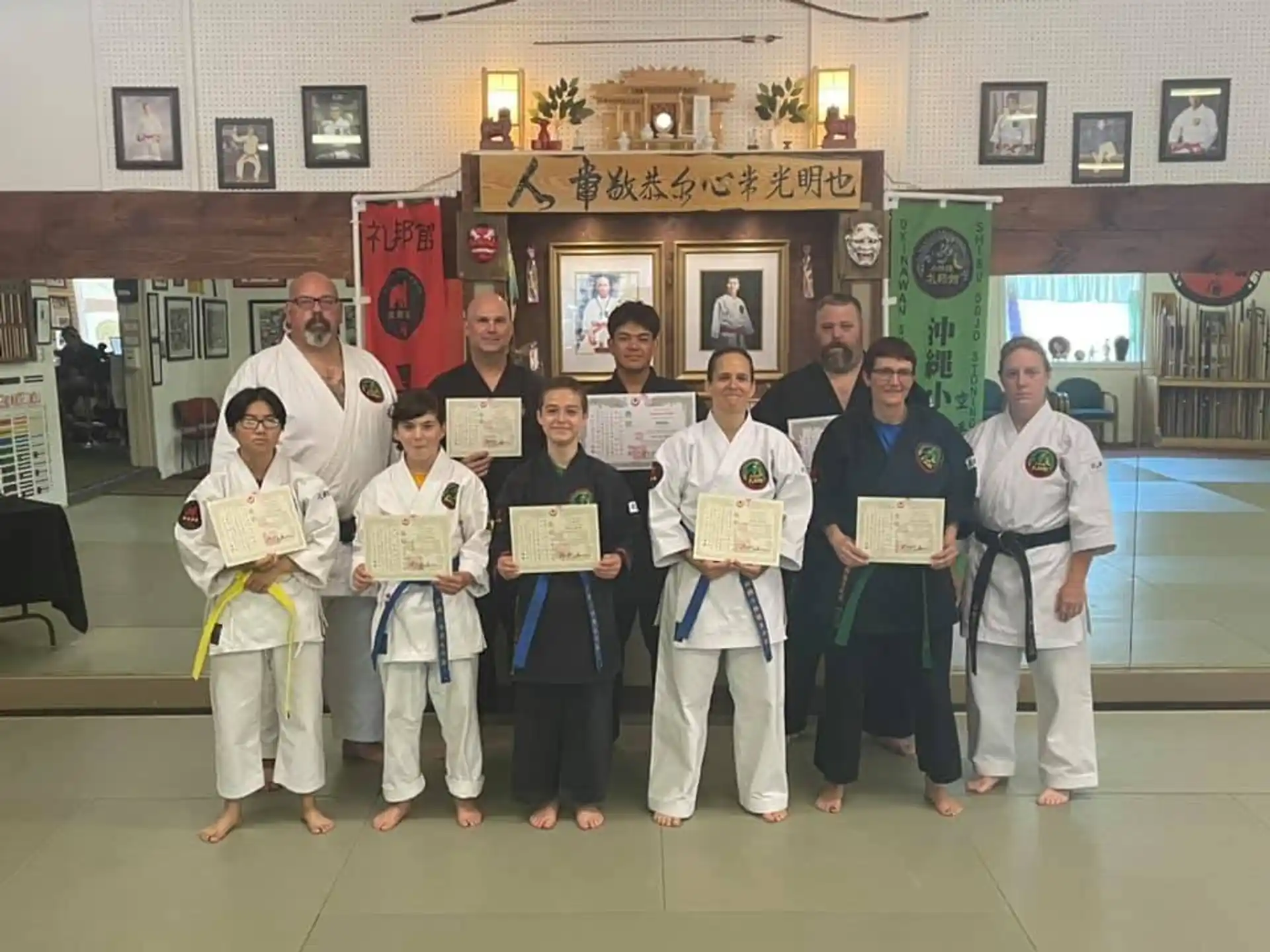 a group of people holding certificates