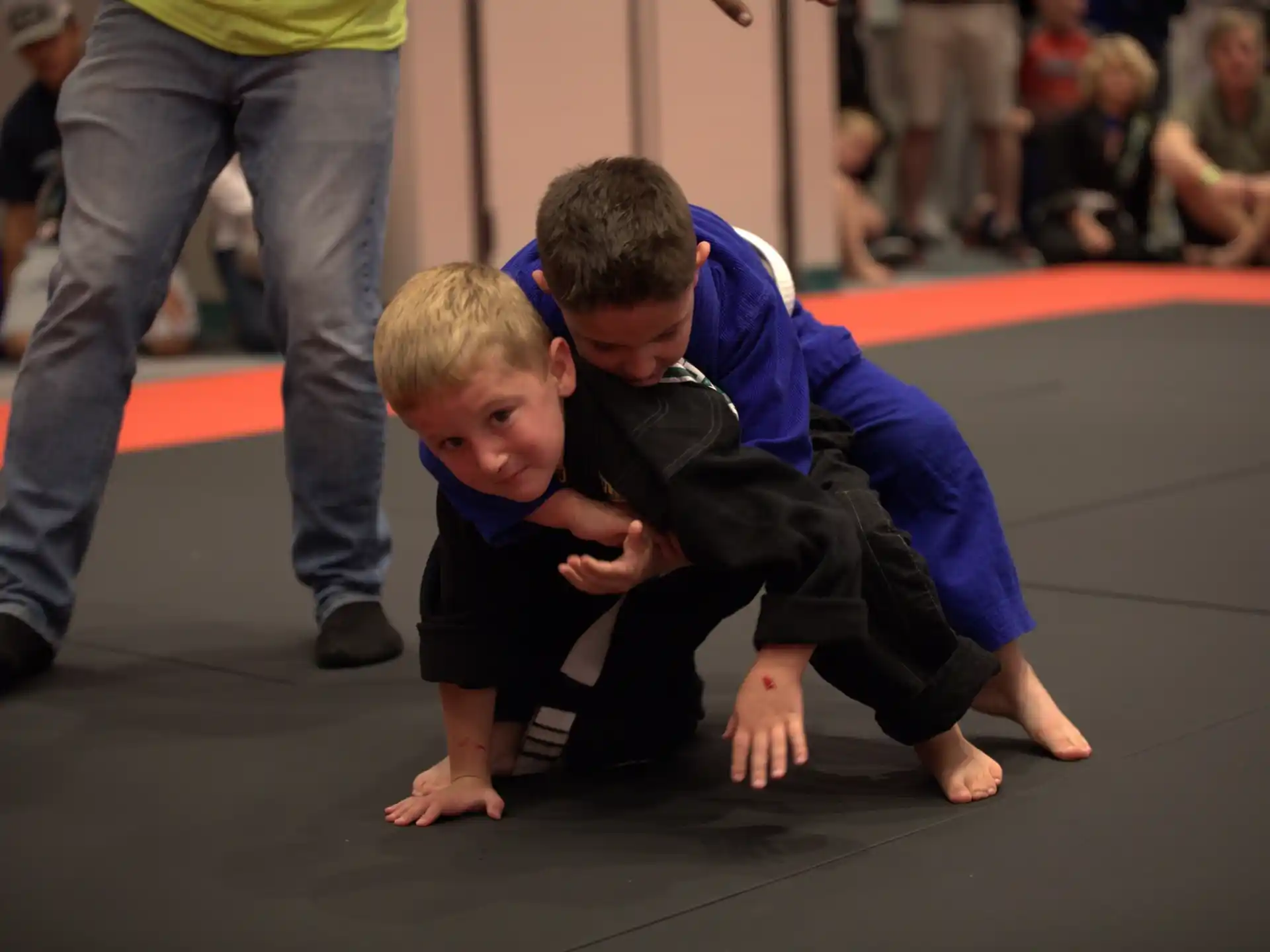 a person helping a boy do push ups