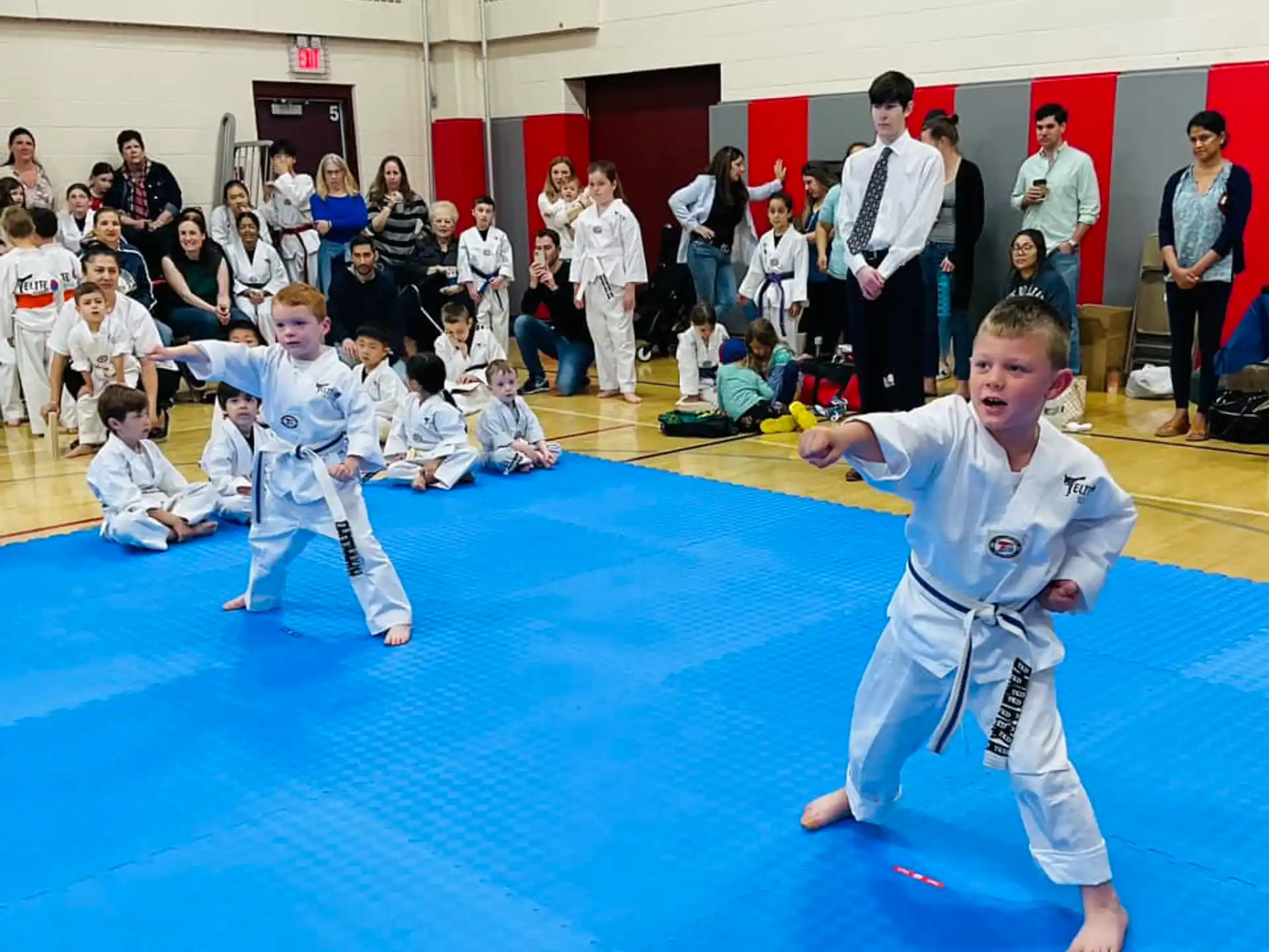 children in karate uniforms in a room