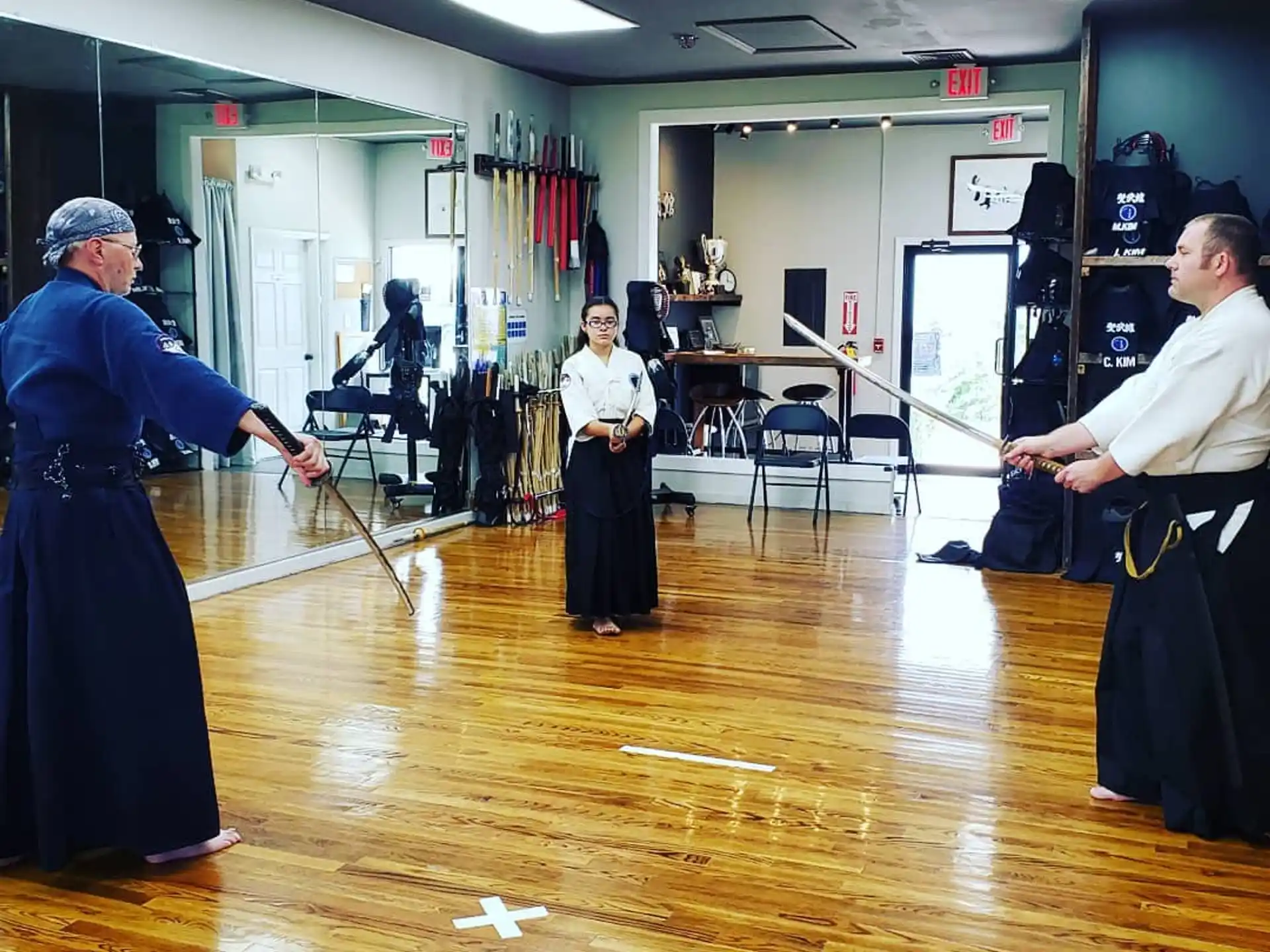 a man holding a sword in a room with other people