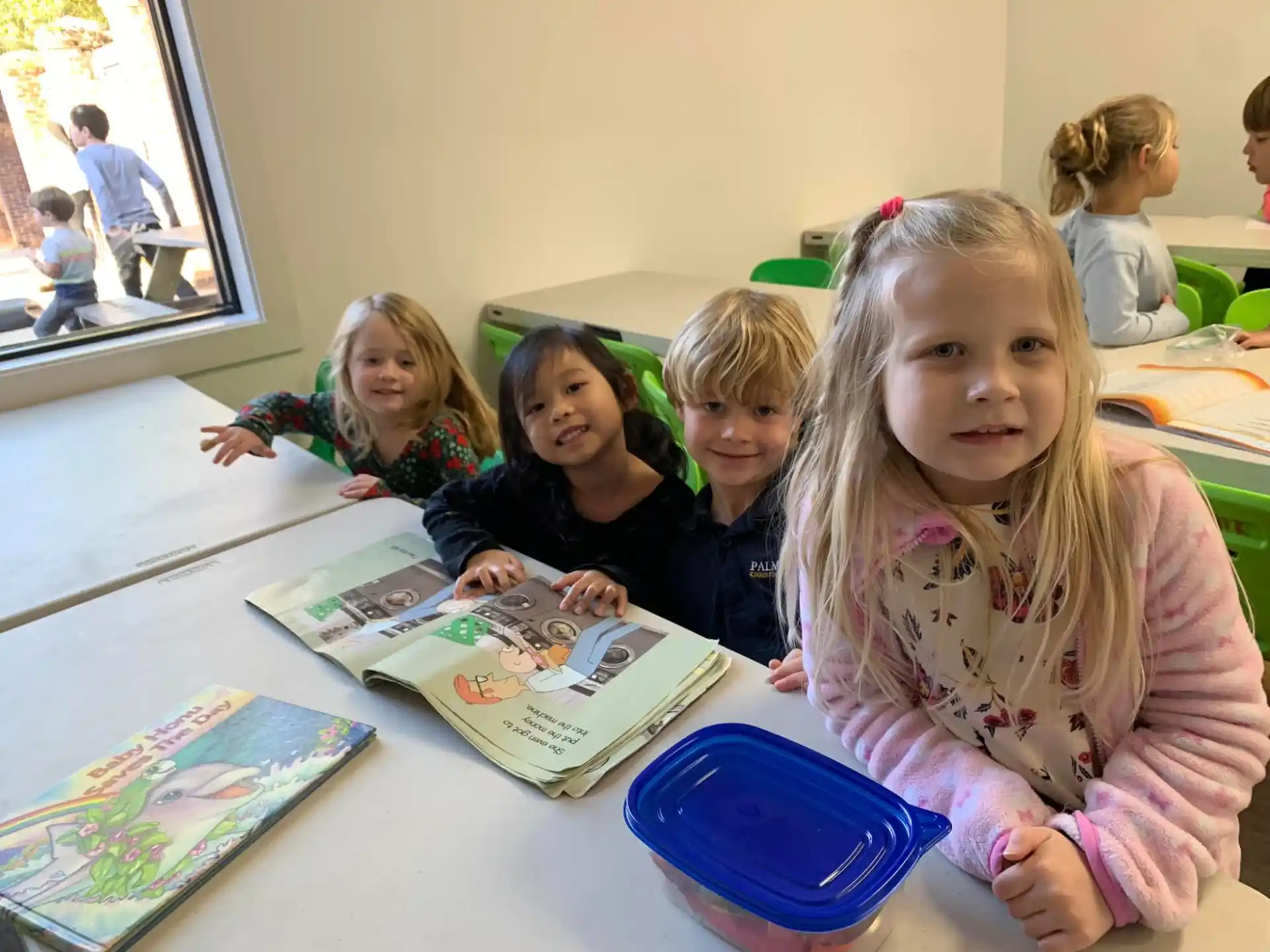 a group of children sitting at a table