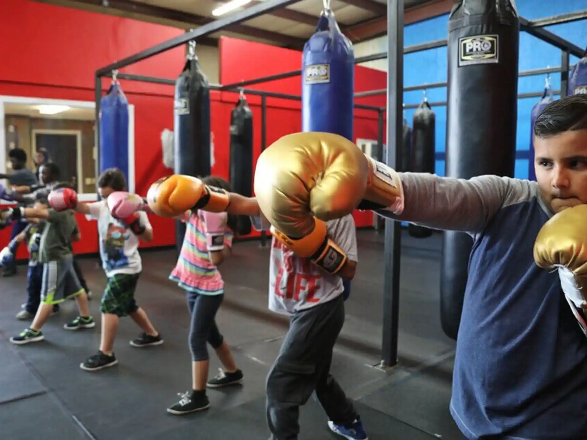 a group of kids playing with boxing gloves