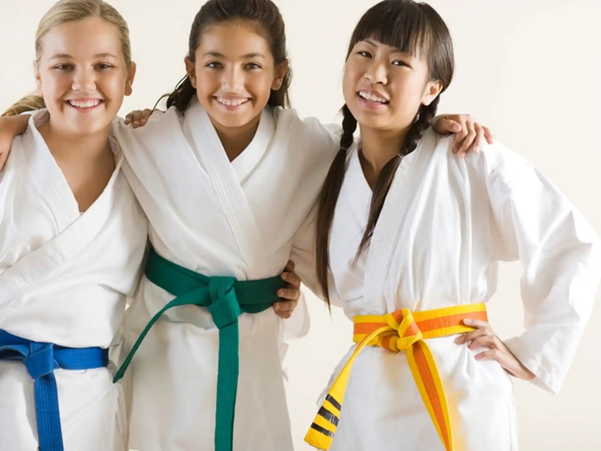 a group of girls wearing white shirts and holding a yellow ribbon