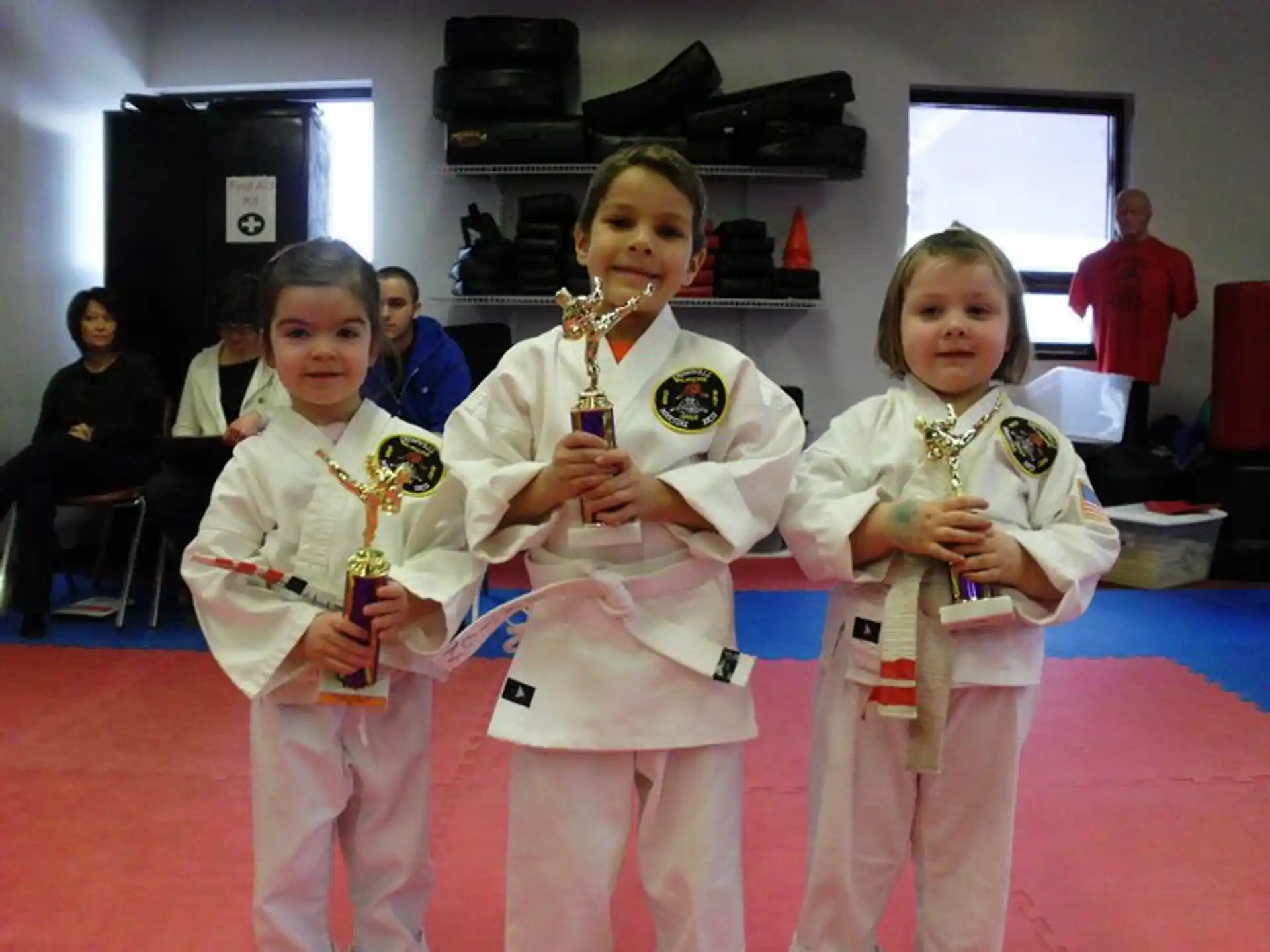 a group of girls in karate uniforms