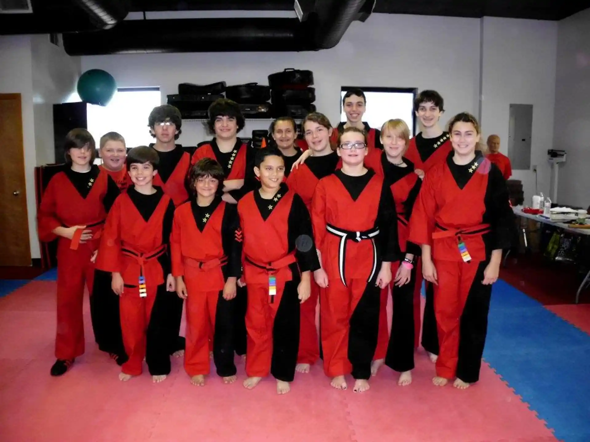 a group of people in red jumpsuits posing for a photo