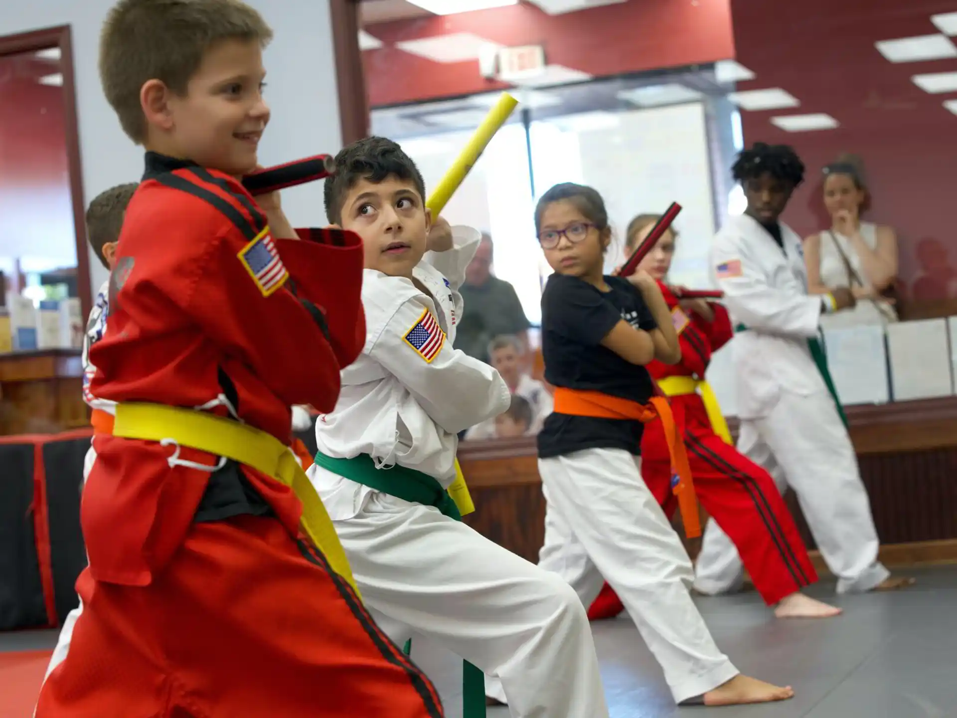 a group of children in karate uniforms