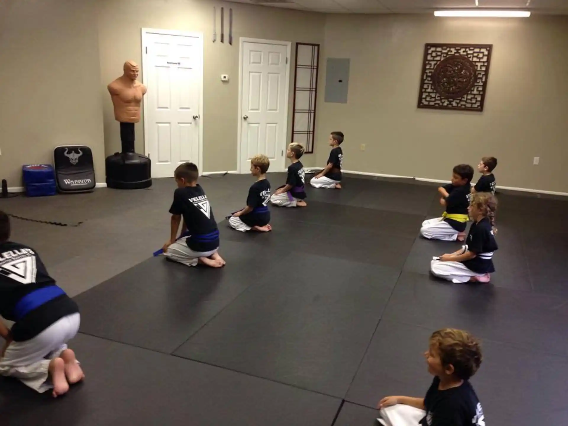 a group of children sitting on the floor in a room