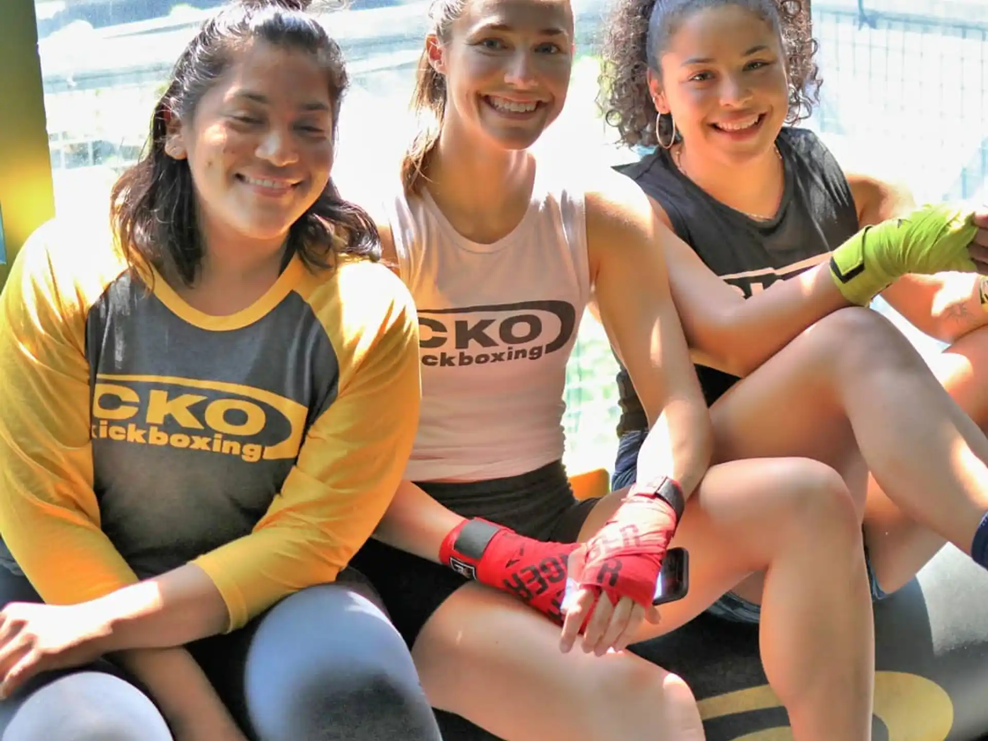a group of girls sitting on a bench