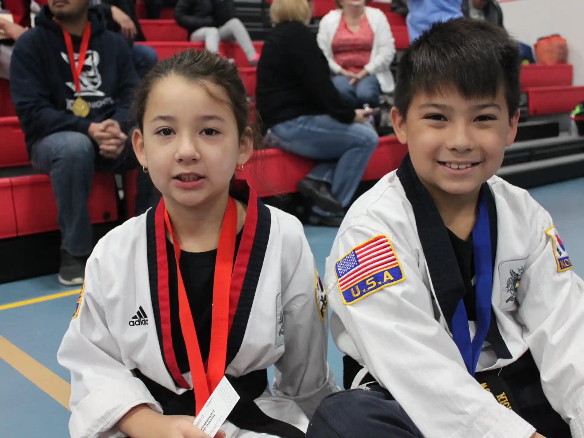 a couple of boys wearing medals