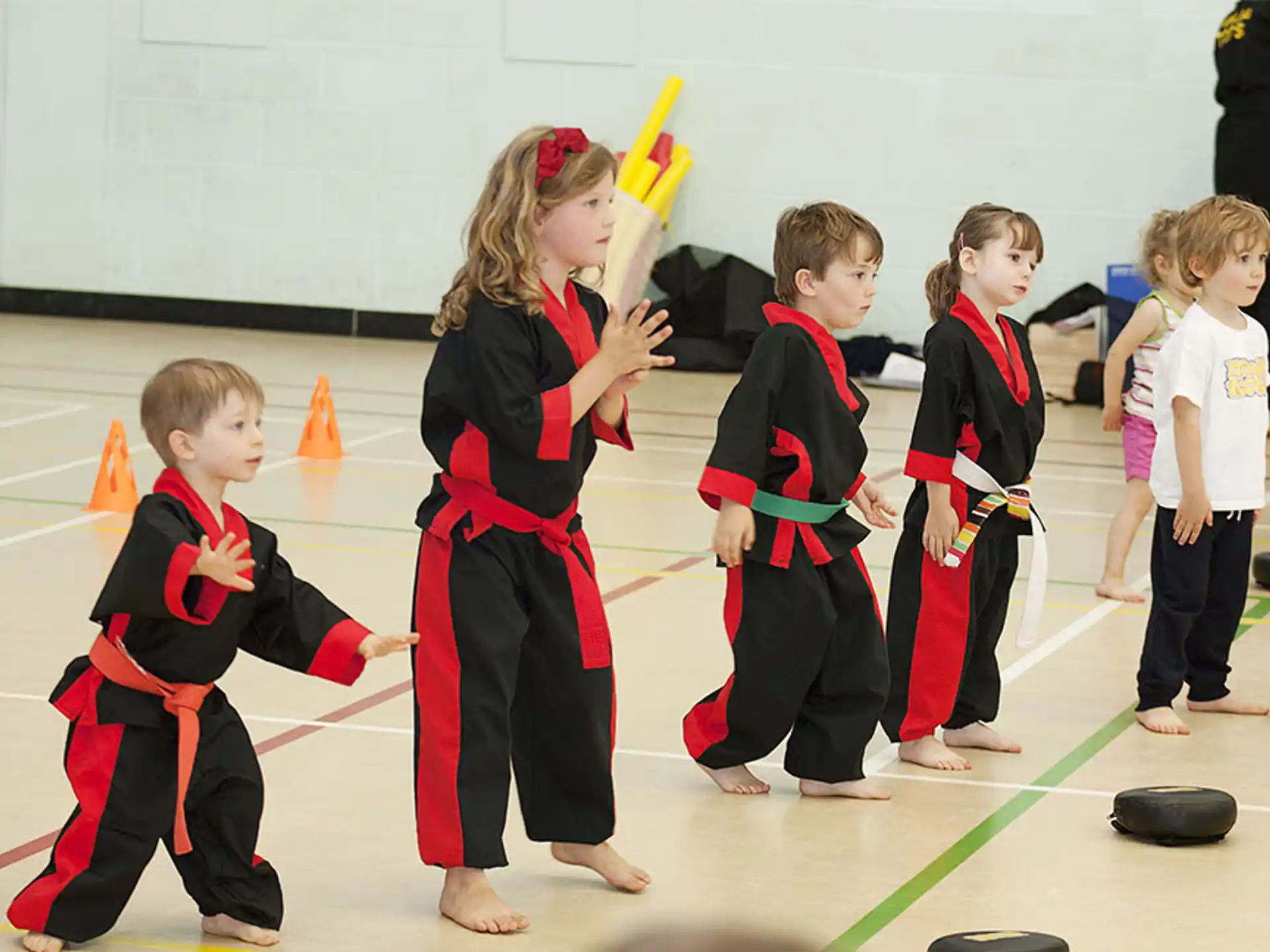 a group of children in karate uniforms