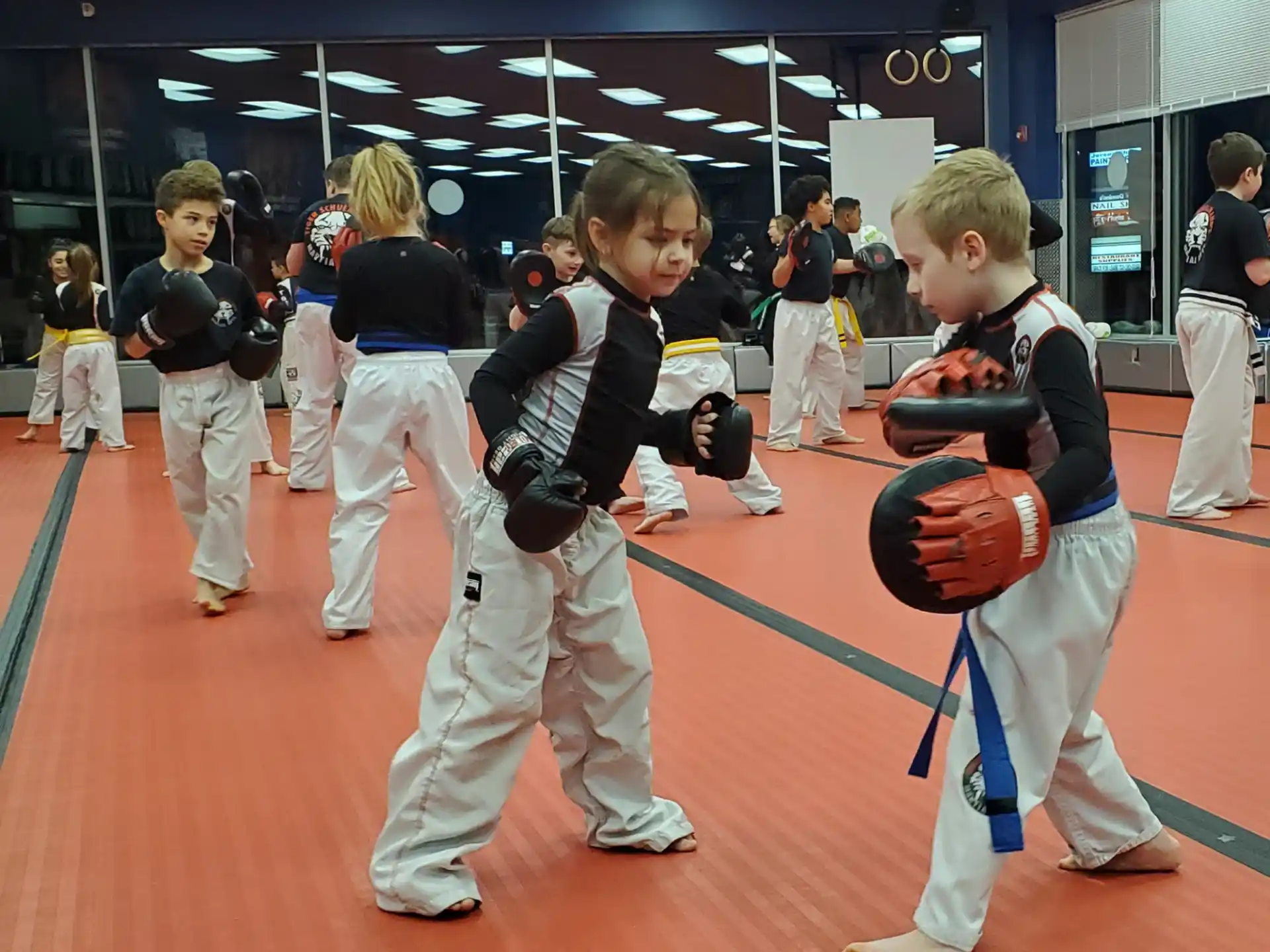 a group of children in karate uniforms