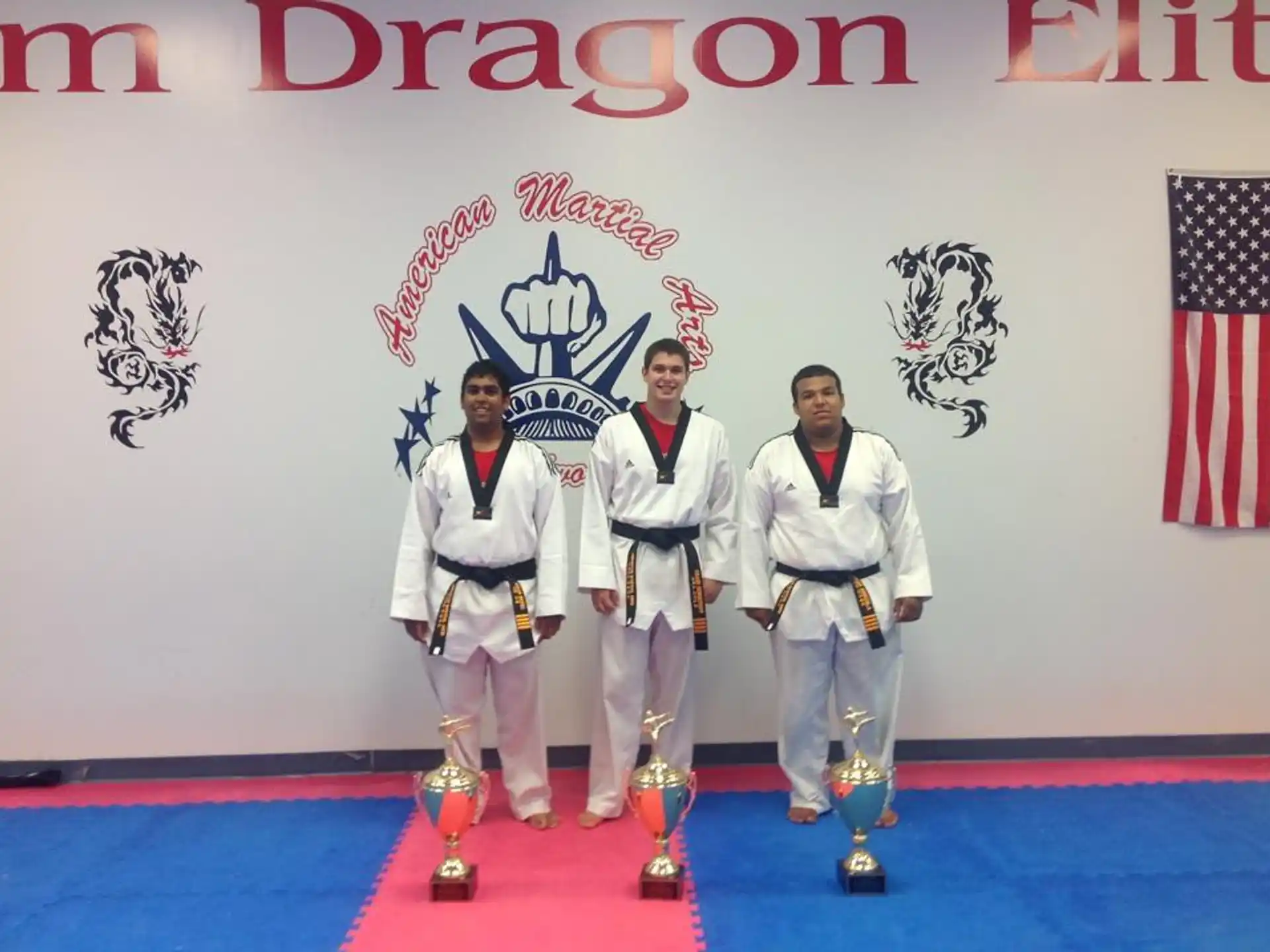 a group of men in white karate uniforms standing on a stage