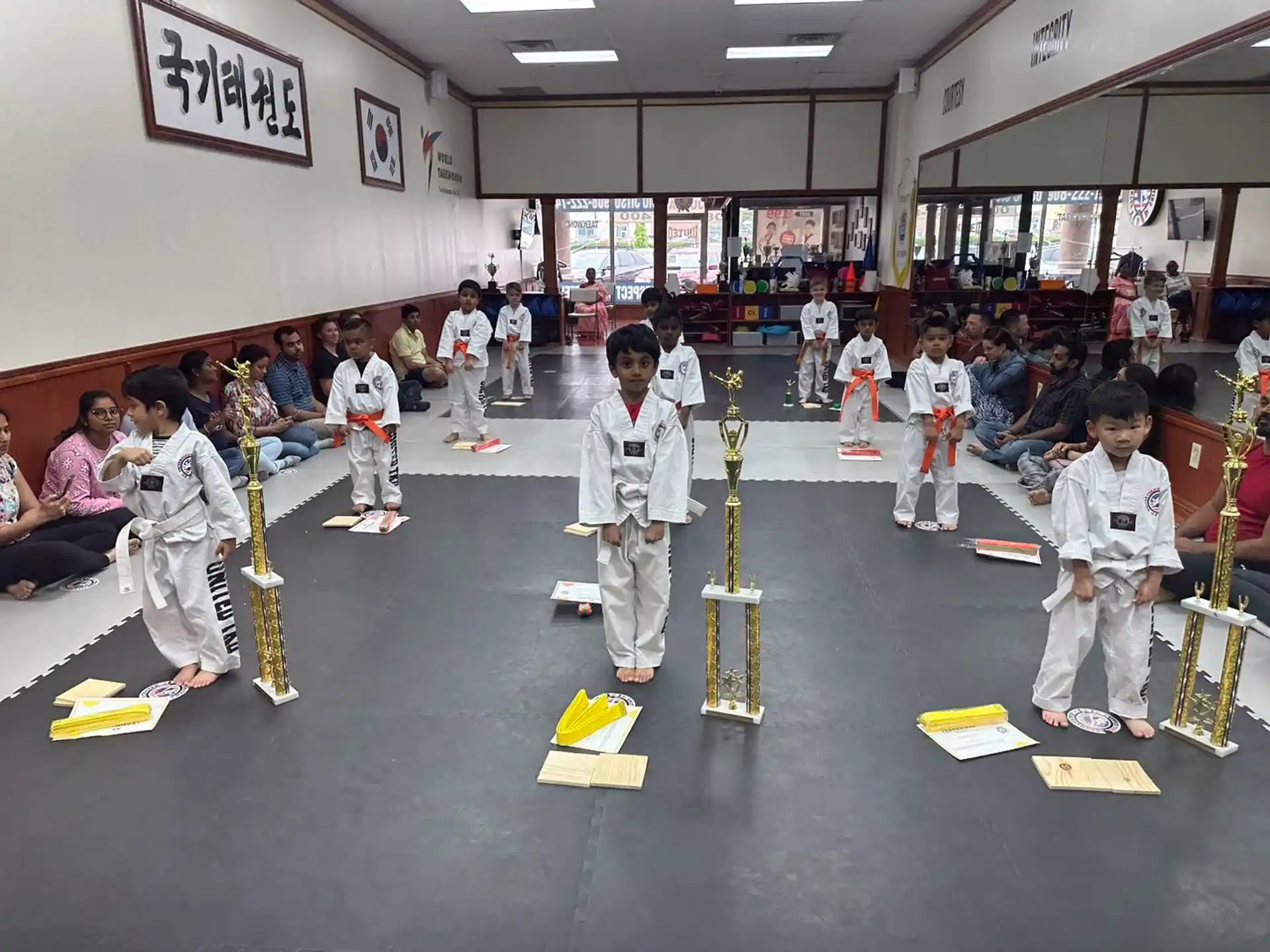 a group of children in karate uniforms