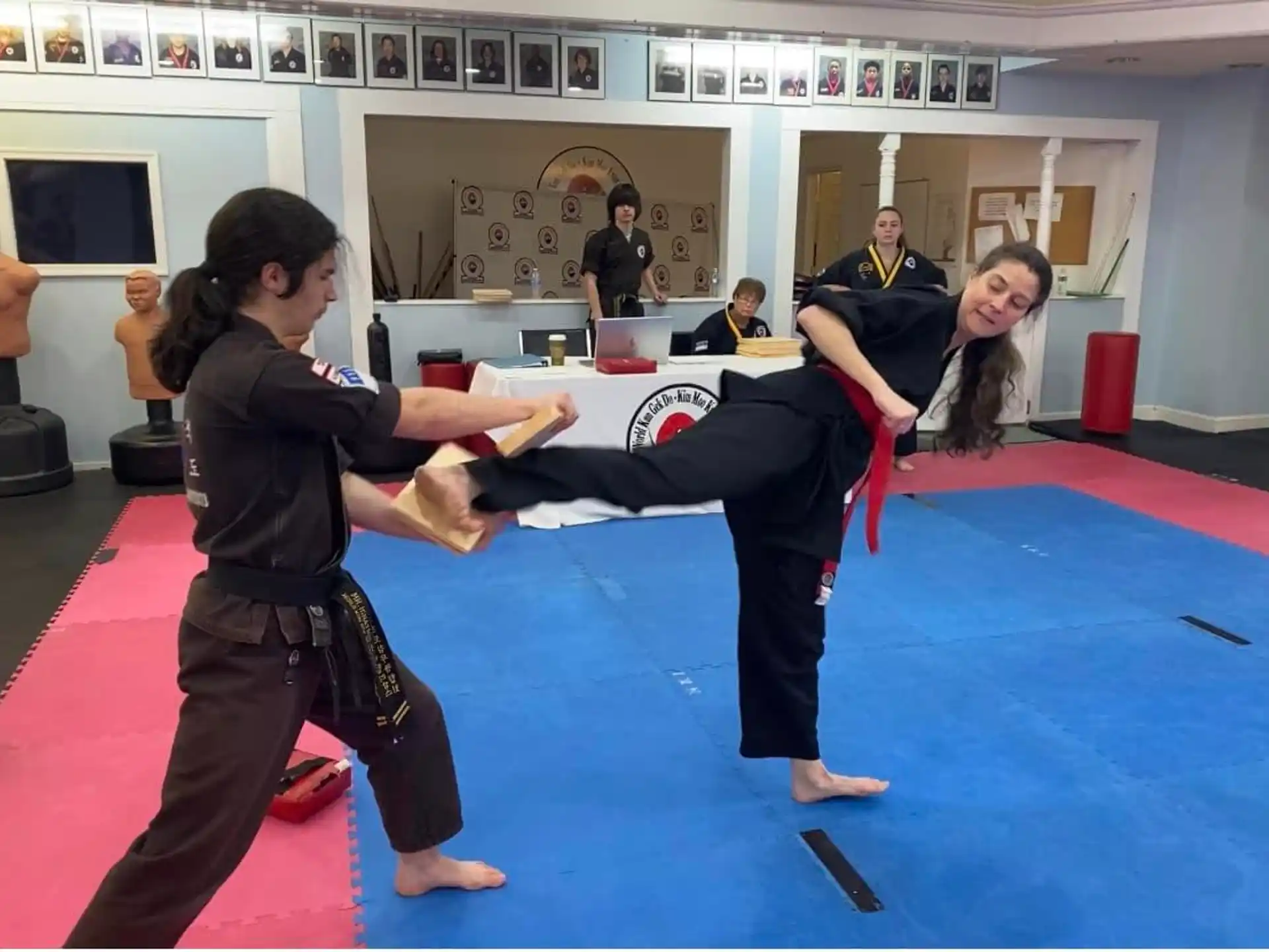 a person holding a girl's leg in a room with other people