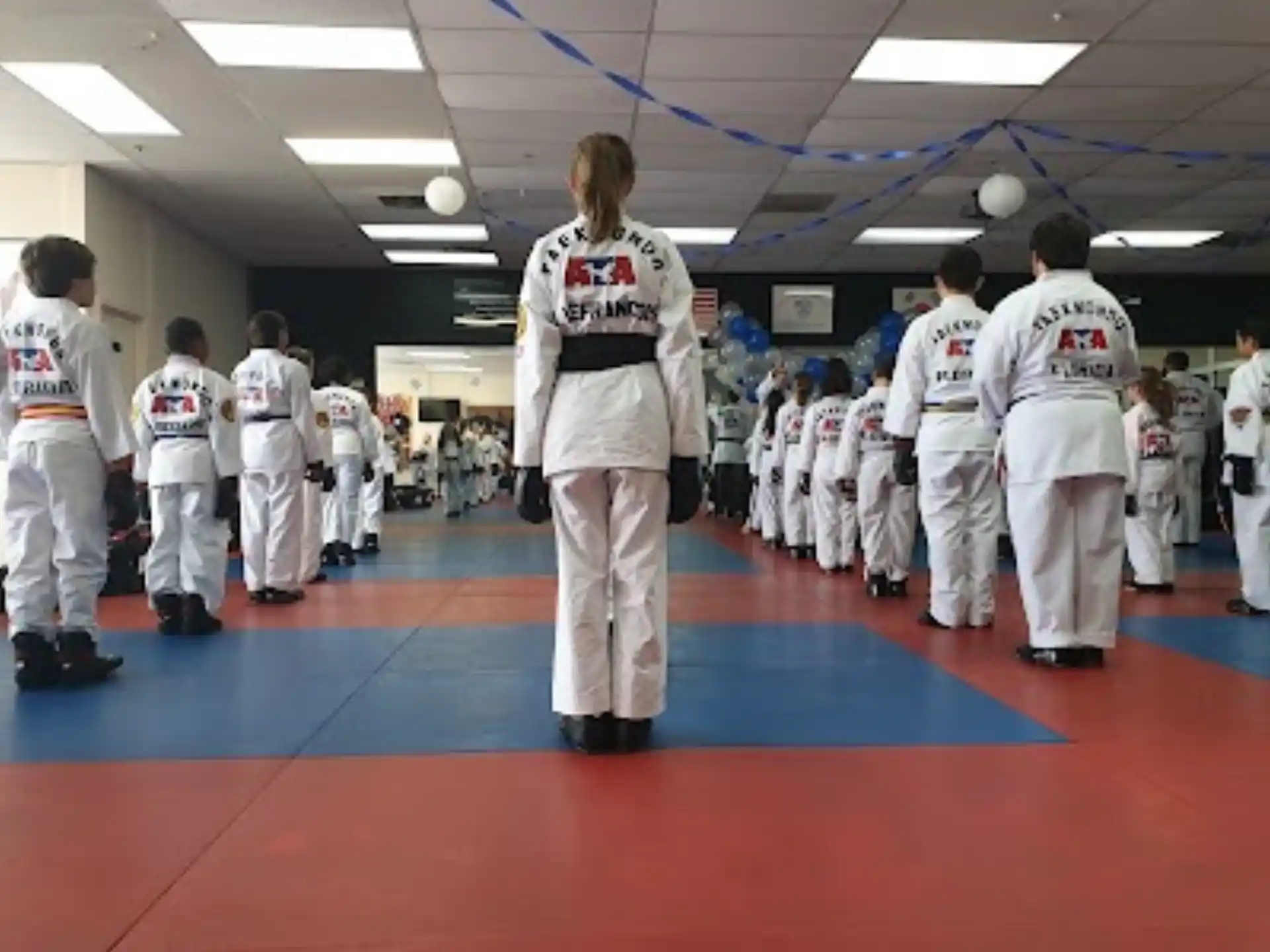 a group of people in white karate uniforms