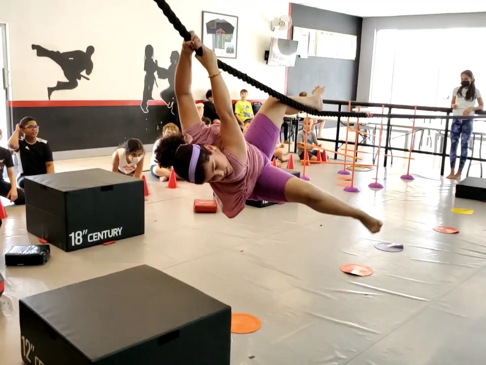 a person doing a handstand on a mat in a gym