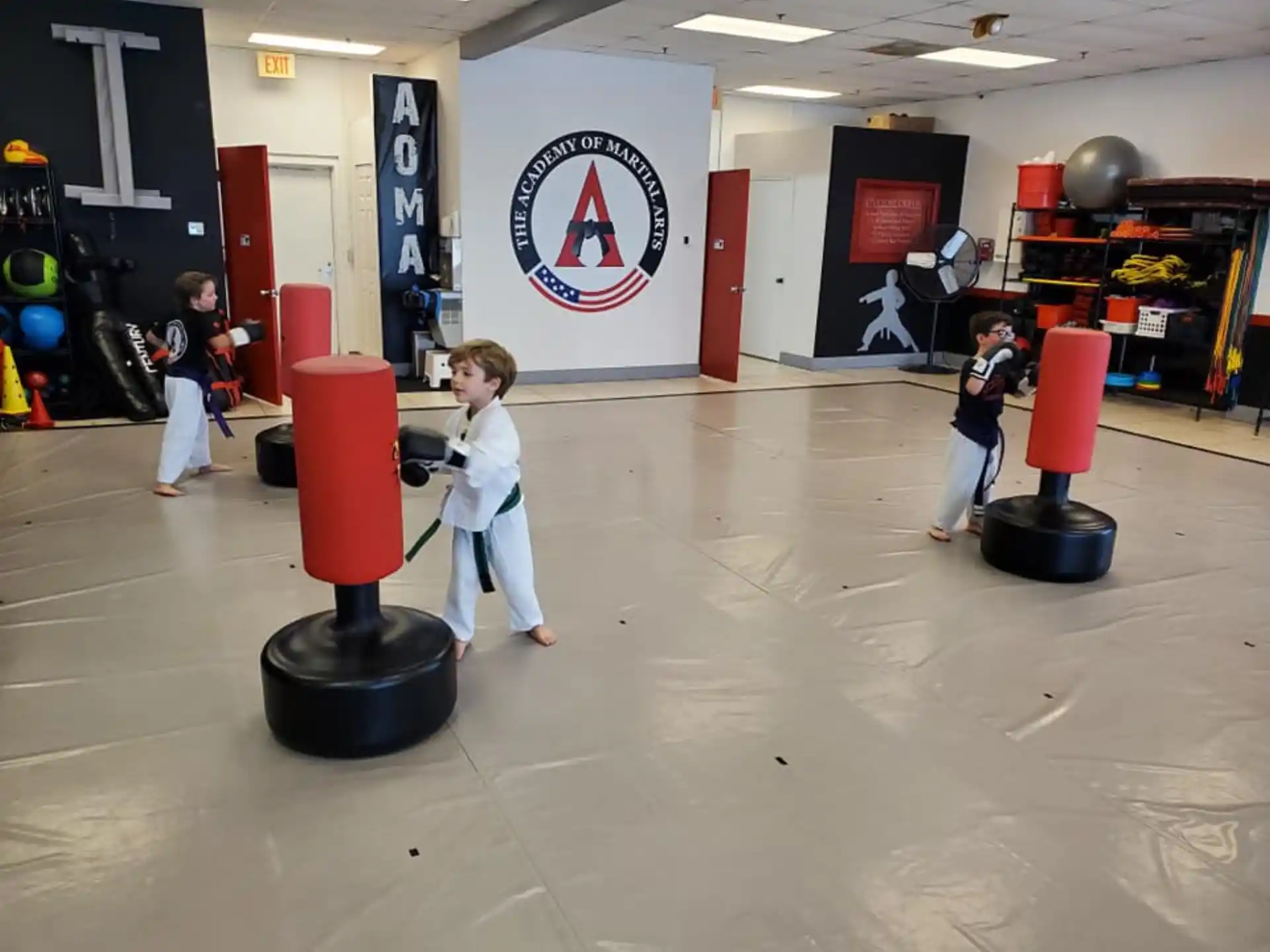 children in a room with a sign