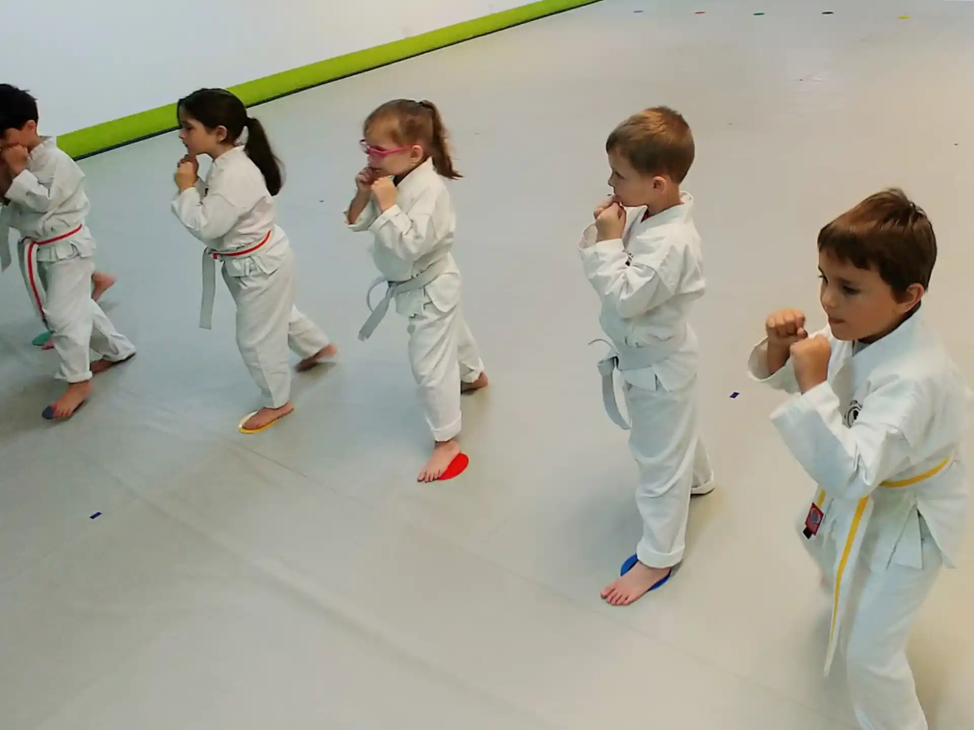 a group of kids in white karate uniforms