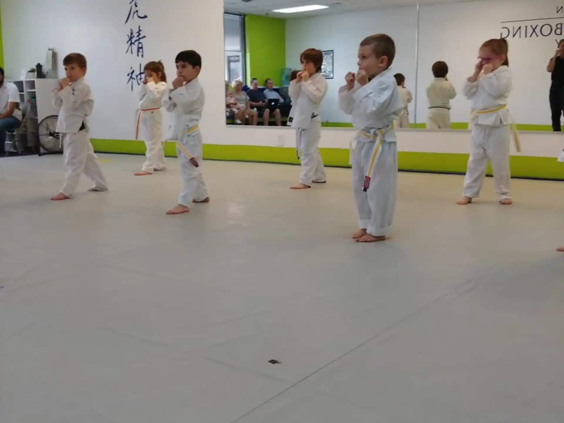 a group of people in white karate uniforms