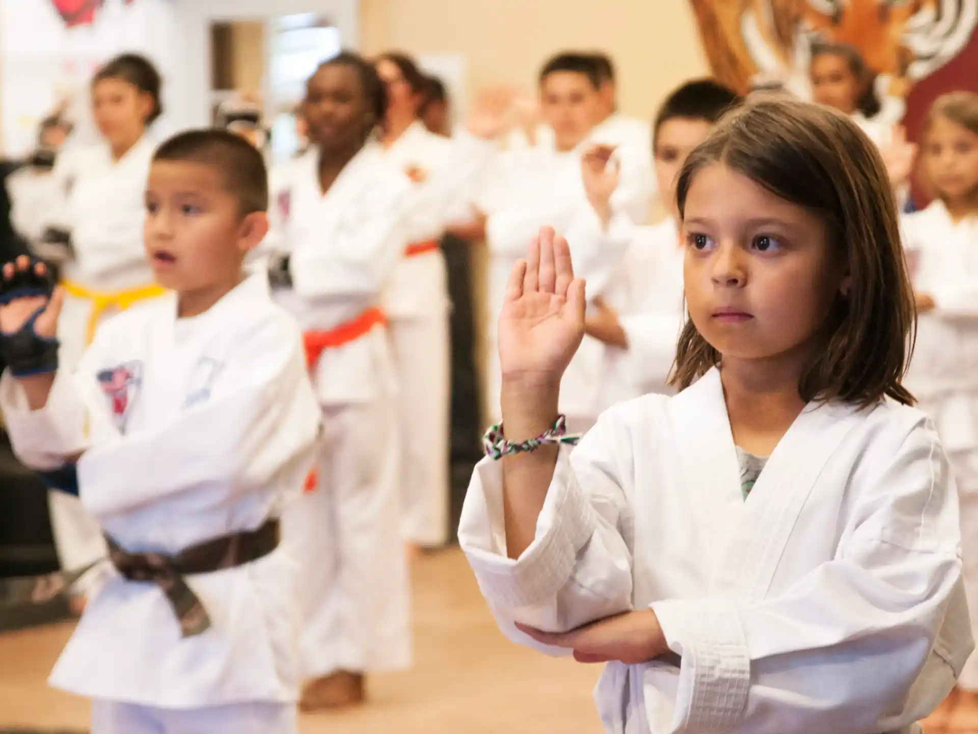a group of children in karate uniforms