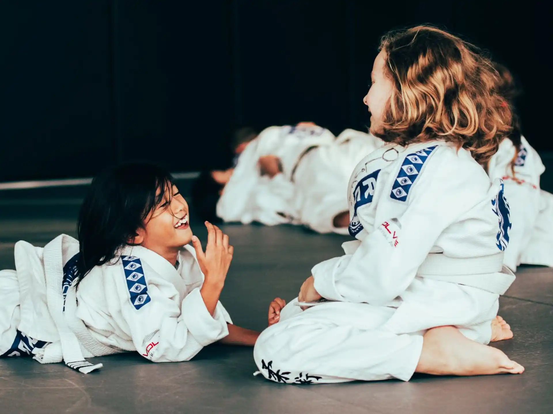a couple of women in karate uniforms